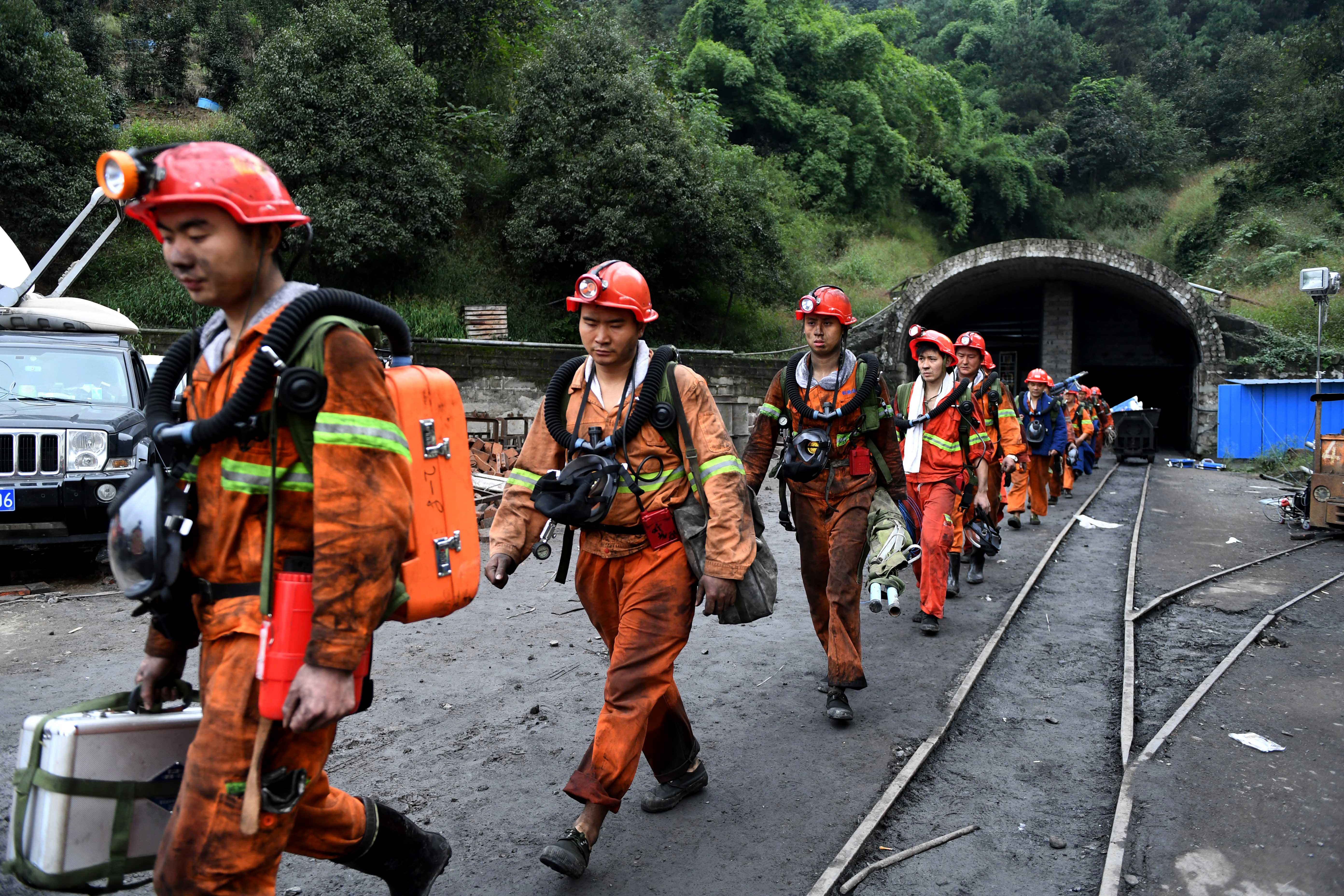 This photo taken on November 1, 2016 shows rescuers exiting Jinshangou Coal Mine in Yongchuan District of Chongqing. All 33 miners missing after a colliery explosion in China earlier this week have been confirmed dead, state media reported on November 2, in the country's latest mining accident. / AFP PHOTO / STRINGER / China OUT