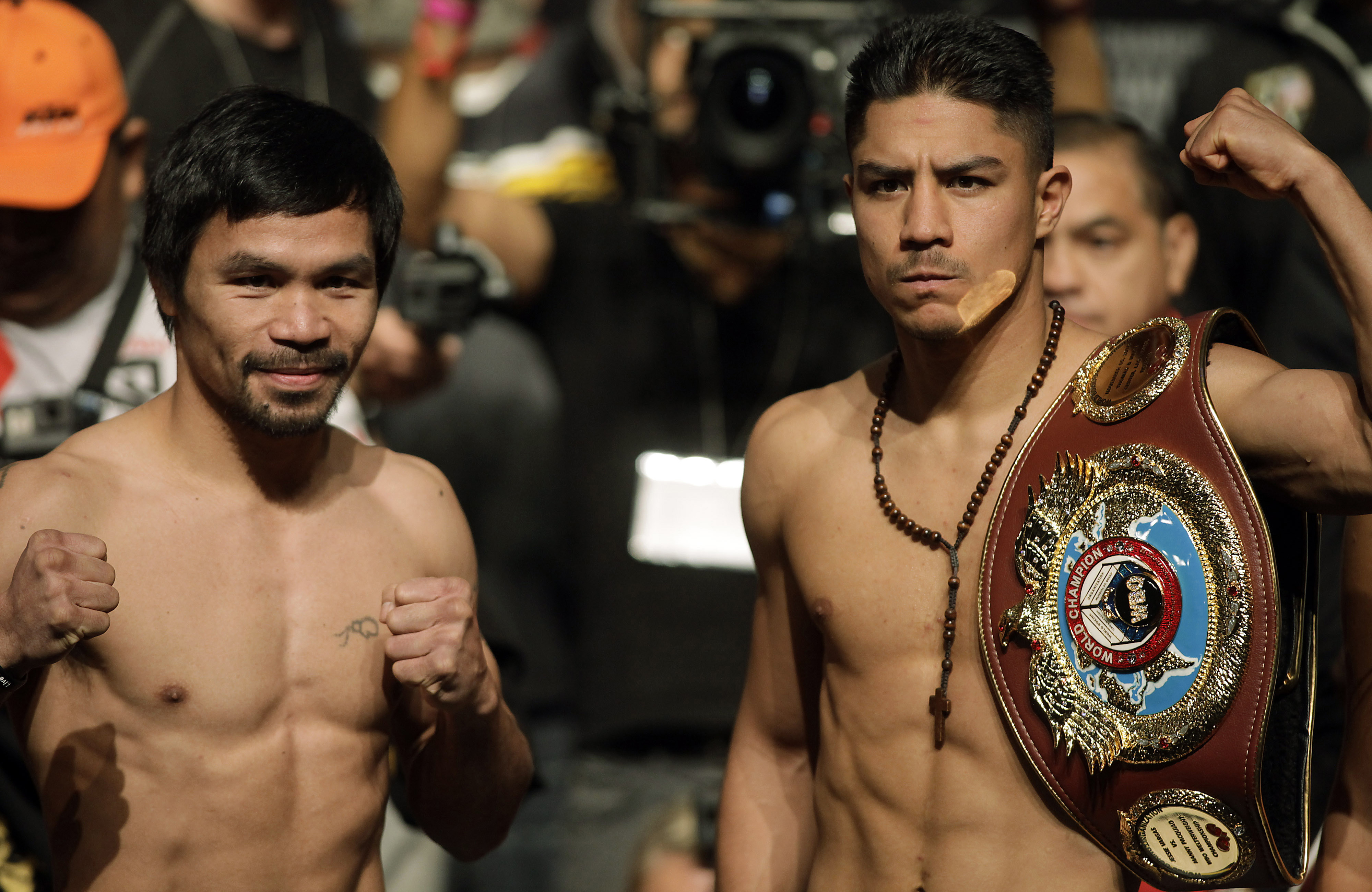 Boxers Manny Pacquiao, Philippines, and Jessie Vargas, USA, pose together during their official weigh-in at the Wynn Las Vegas hotel in Las Vegas, Nevada on November 4, 2016.   Pacquiao will challenge Vargas for the WBO Welterweight Title Saturday, November 5, 2016 at the Thomas & Mack Center.  / AFP PHOTO / John GURZINSKI