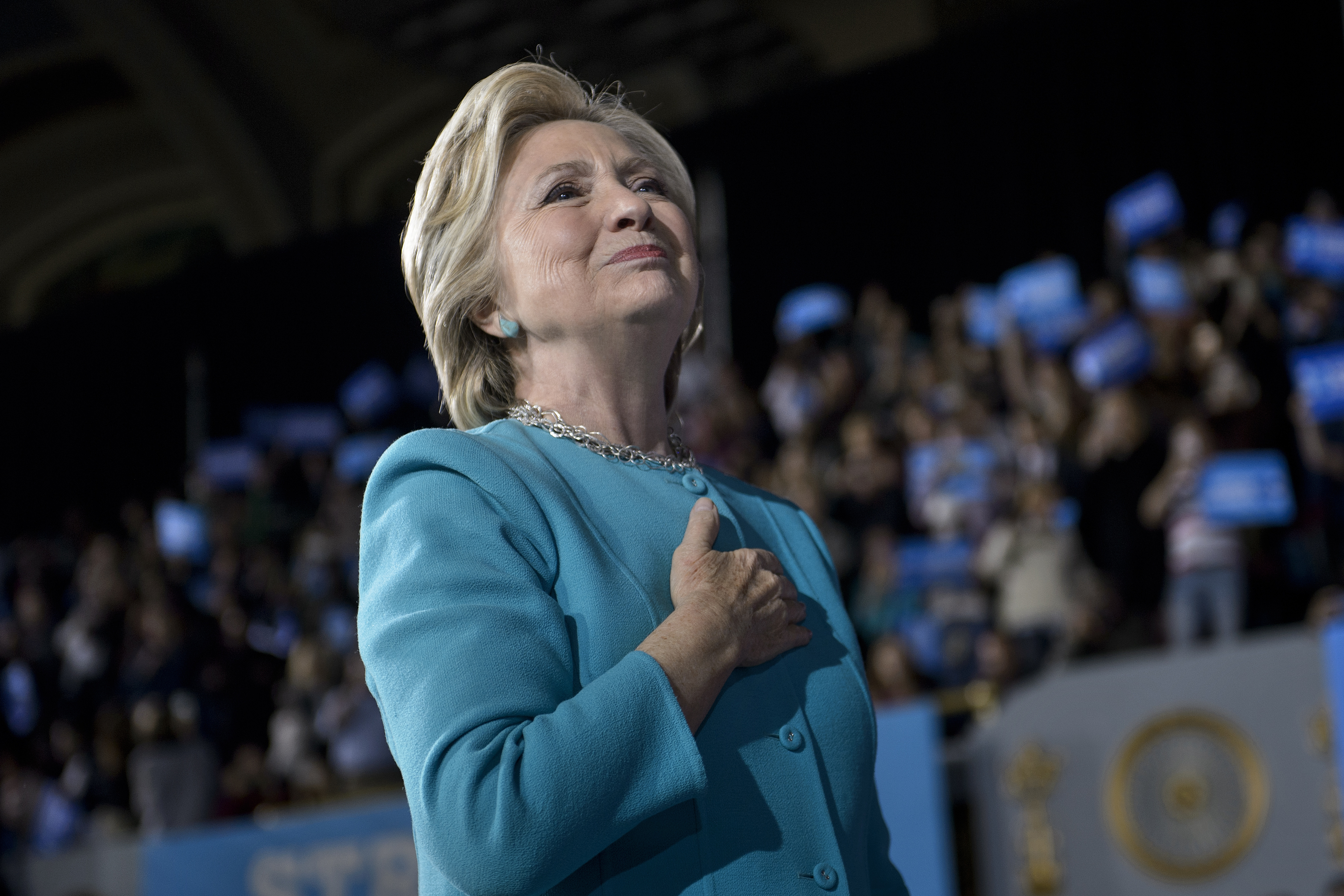 Democratic presidential nominee Hillary Clinton acknowledges supporters after speaking a rally at the Cleveland Public Auditorium November 6, 2016 in Cleveland, Ohio. Donald Trump barnstorms five states Sunday while Hillary Clinton implores her most fervent supporters to get to the polls, in a frenetic final 48-hour dash to the US presidential election. / AFP PHOTO / Brendan Smialowski