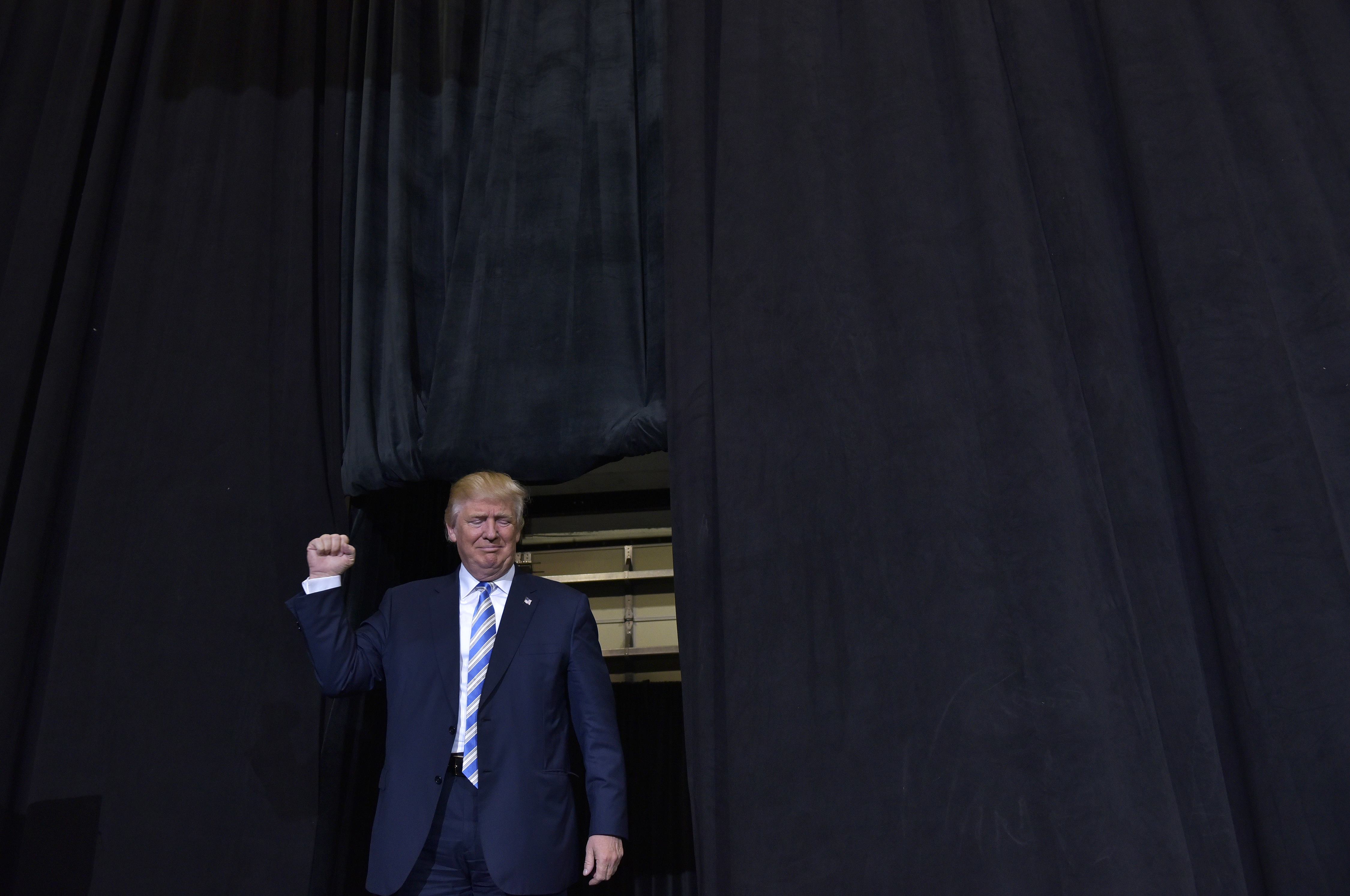 Republican presidential nominee Donald Trump arrives for a rally in the Robarts Arena of the Sarasota Fairgrounds on November 7, 2016 in Sarasota, Florida. Hillary Clinton and Donald Trump launched into the frenzied final day of their historic fight for the White House Monday, with blow-out rallies in the handful of swing states that will decide who leads the United States. / AFP PHOTO / MANDEL NGAN