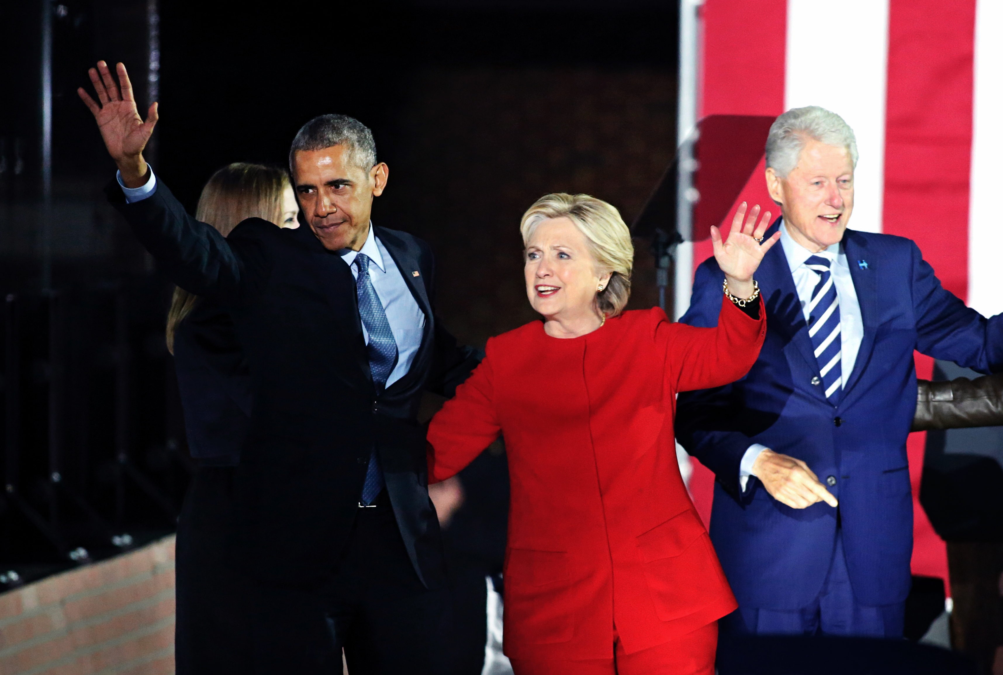 US Democratic presidential nominee Hillary Clinton (C), US President Barack Obama (L), and former US president Bill Clinton (R) wave to the crowd after a rally on Independence Mall in Philadelphia, Pennsylvania, November 07, 2016 About 40,000 people flooded Independence Mall in Philadelphia for Hillary Clinton's rally with her husband Bill, President Barack Obama and his wife Michelle at her side, a campaign aide said. The attendance set a new record for Clinton, with the previous high point a rally in Ohio that drew 18,500 people, a campaign aide told reporters traveling with the candidate. / AFP PHOTO / KENA BETANCUR