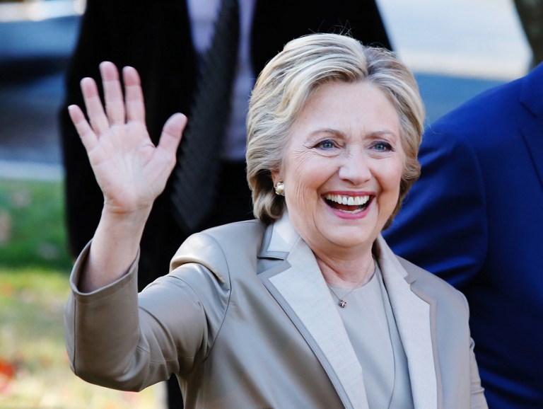 Democratic presidential nominee Hillary Clinton greets supporters after casting her vote in Chappaqua, New York on November 08, 2016. Chanting "Madam President," about 150 supporters turned out to cheer on the Democratic nominee who voted with husband Bill Clinton at an elementary school near their home in Chappaqua / AFP PHOTO / EDUARDO MUNOZ ALVAREZ