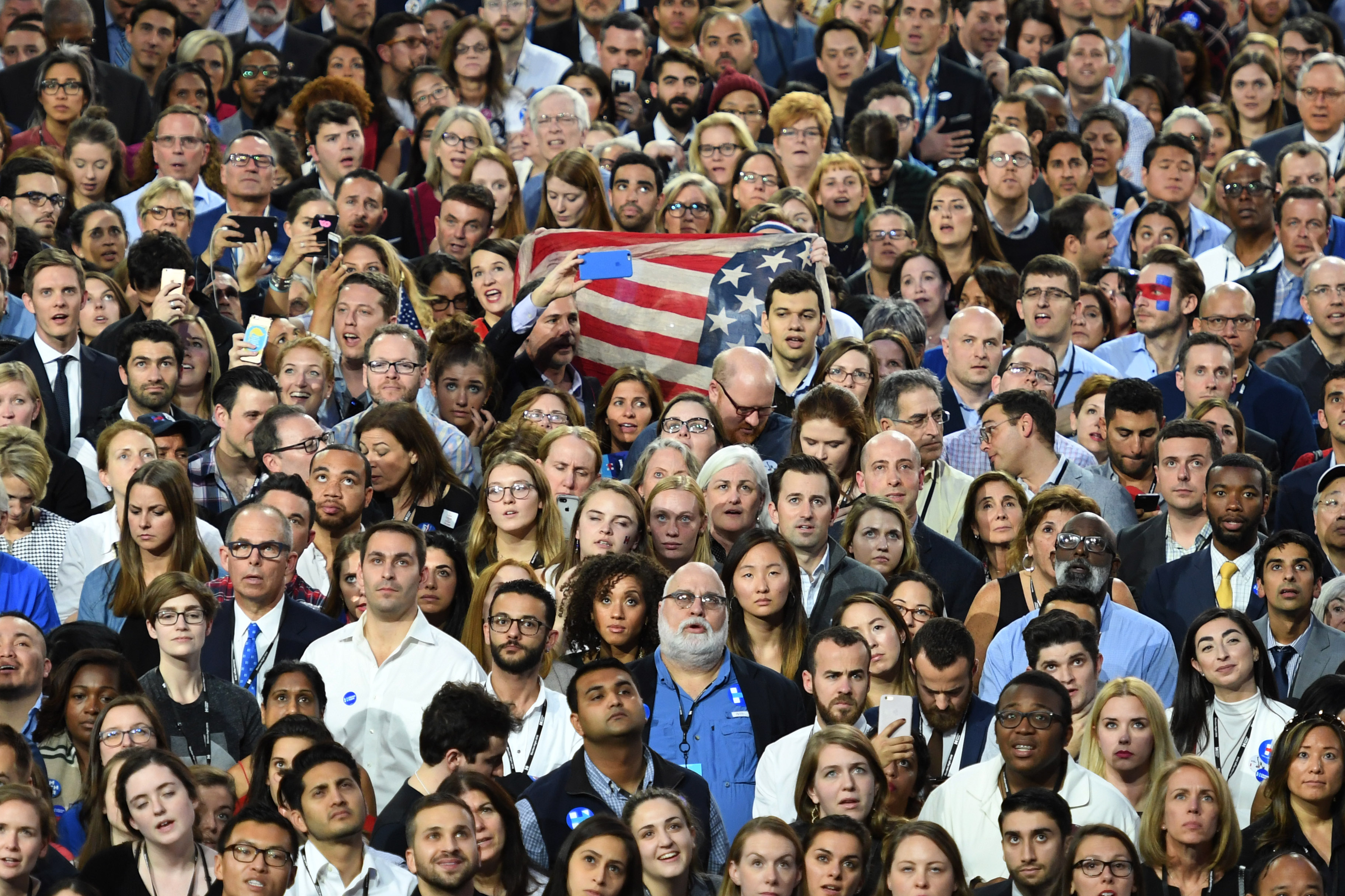 Democratic presidential nominee Hillary Clinton supporters watch the result unfold on a giant screen during election night at the Jacob K. Javits Convention Center in New York on November 8, 2016. Eager voters crowded into polling stations to choose a new US president Tuesday after a wild and bitter contest between the billionaire populist Donald Trump and Hillary Clinton, the Democrat seeking to become the first woman to win the White House. / AFP PHOTO / ANGELA WEISS