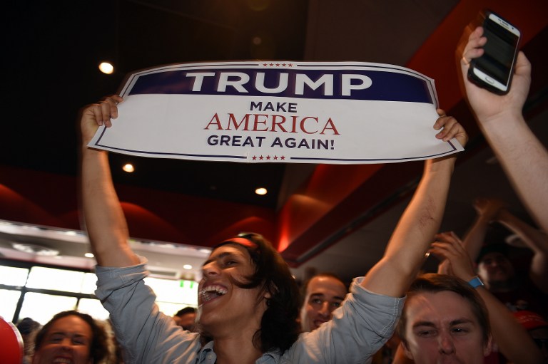 Supporters of US presidential canditate Donald Trump celebrates his seats at the United States Studies Center at the University of Sydney on November 9, 2016. Australian stocks climbed 0.80 percent at the open in anticipation of a victory for Hillary Clinton in the US presidential election. / AFP PHOTO / SAEED KHAN