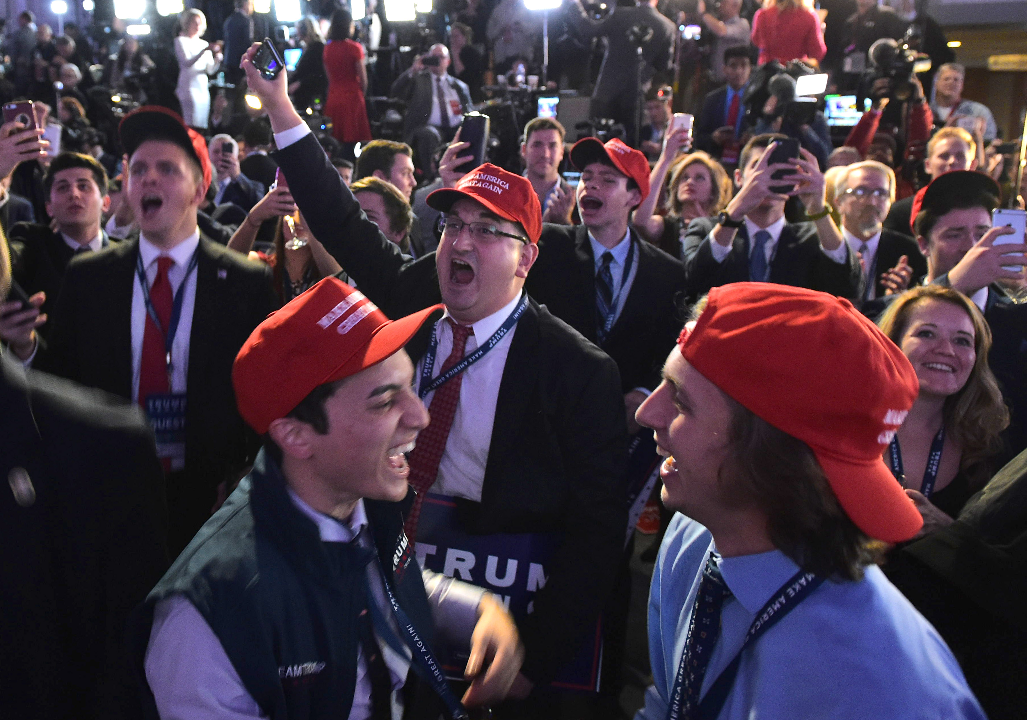 Supporters of Republican presidential nominee Donald Trump react to early poll results during election night at the New York Hilton Midtown in New York on November 8, 2016. / AFP PHOTO / Mandel NGAN