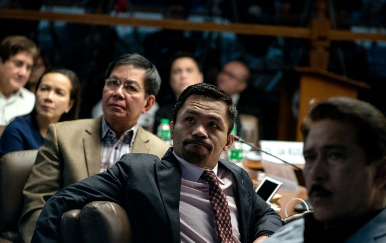 Philippine Senator and boxer Manny Pacquiao (2nd R) sits with Senators Tito Sotto (R), Gregorio Honasan (L), Grace Poe (2nd L) and Panfilo Lacson (3rd L) as they watch a presentation showing the body of Albuera Mayor Rolando Espinosa during a senate hearing investigating Espinosa's death in Manila on November 10, 2016. Espinosa, who President Rodrigo Duterte named as being involved in the illegal drug trade, was shot dead in jail on November 5, police said, the second local official implicated in narcotics to be killed in two weeks. / AFP PHOTO / NOEL CELIS