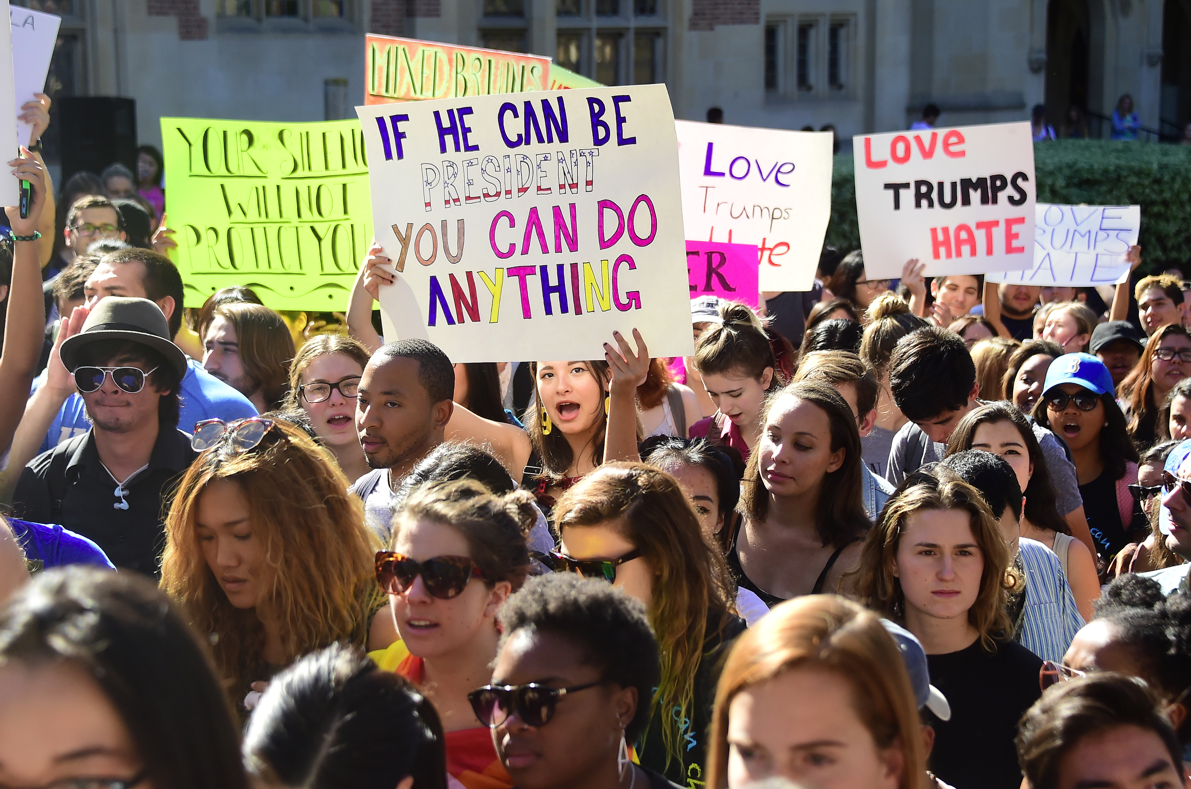 University of California Loas Angeles students march through campus on November 10, 2016 in Los Angeles, California, during a "Love Trumps Hate" rally in reaction to President-elect Donald Trump's victory in the presidential elections. / AFP PHOTO