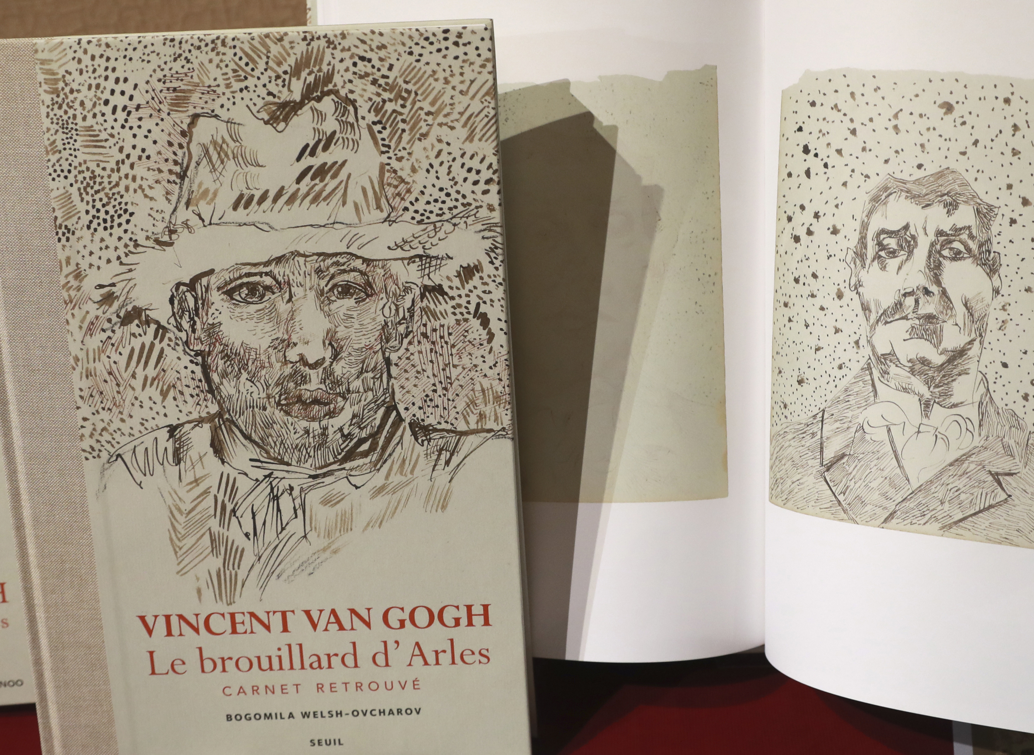 This picture taken on November 15, 2016, shows a book of drawings from Dutch post-impressionist painter Vincent Van Gogh displayed during a press conference at the architecture academy in Paris. / AFP PHOTO / JACQUES DEMARTHON