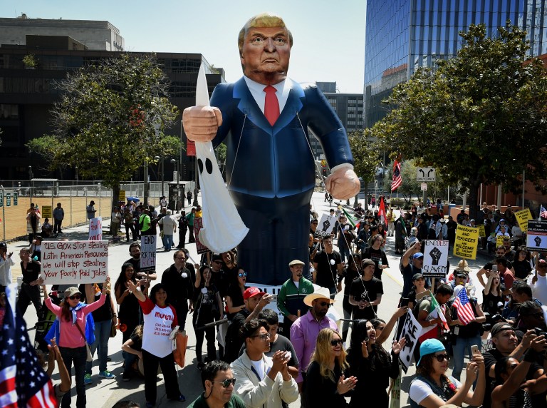 (FILES) This file photo taken on May 01, 2016 shows Members of the 'Full Rights for Immigrants Coalition' displaying a giant effigy of US Republican Party presidential hopeful Donald Trump during a protest on May Day in Los Angeles, California on May 1, 2016. State officials, religious leaders and rights groups in California are struggling to reassure immigrants after the election of Donald Trump, urging unity and vowing support but also bracing for the worst. / AFP PHOTO / GETTY IMAGES NORTH AMERICA / Mark Ralston