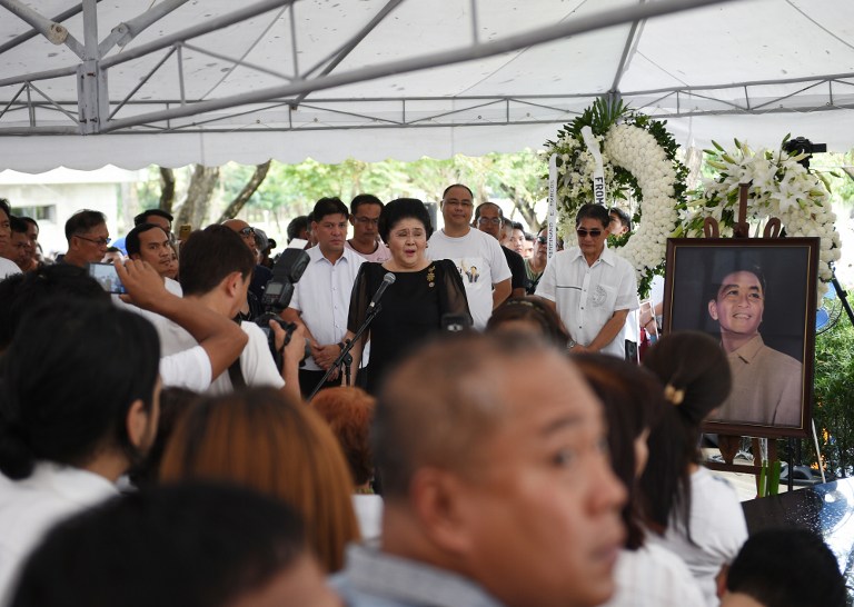 Philippines' former first lady Imelda Marcos (C) speaks to supporters at the graveyard of the late dictator Ferdinand Marcos at the national heroes' cemetery in Manila on November 19, 2016, a day after the late president was buried. Ex-Philippine dictator Marcos was buried in a secretive ceremony at the national heroes' cemetery on November 18, triggering street protests as opponents denounced what they said was the whitewashing of his brutal and corrupt rule. / AFP PHOTO / Ted ALJIBE