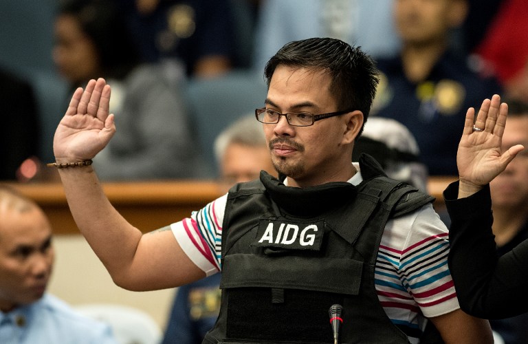 Kerwin Espinosa, son of the late mayor Rolando Espinosa, takes an oath during the Senate drug hearing at the Senate building in Manila on November 23, 2016. Kerwin was arrested in the United Arab Emirates last month and will face drug trafficking charges. / AFP PHOTO / NOEL CELIS