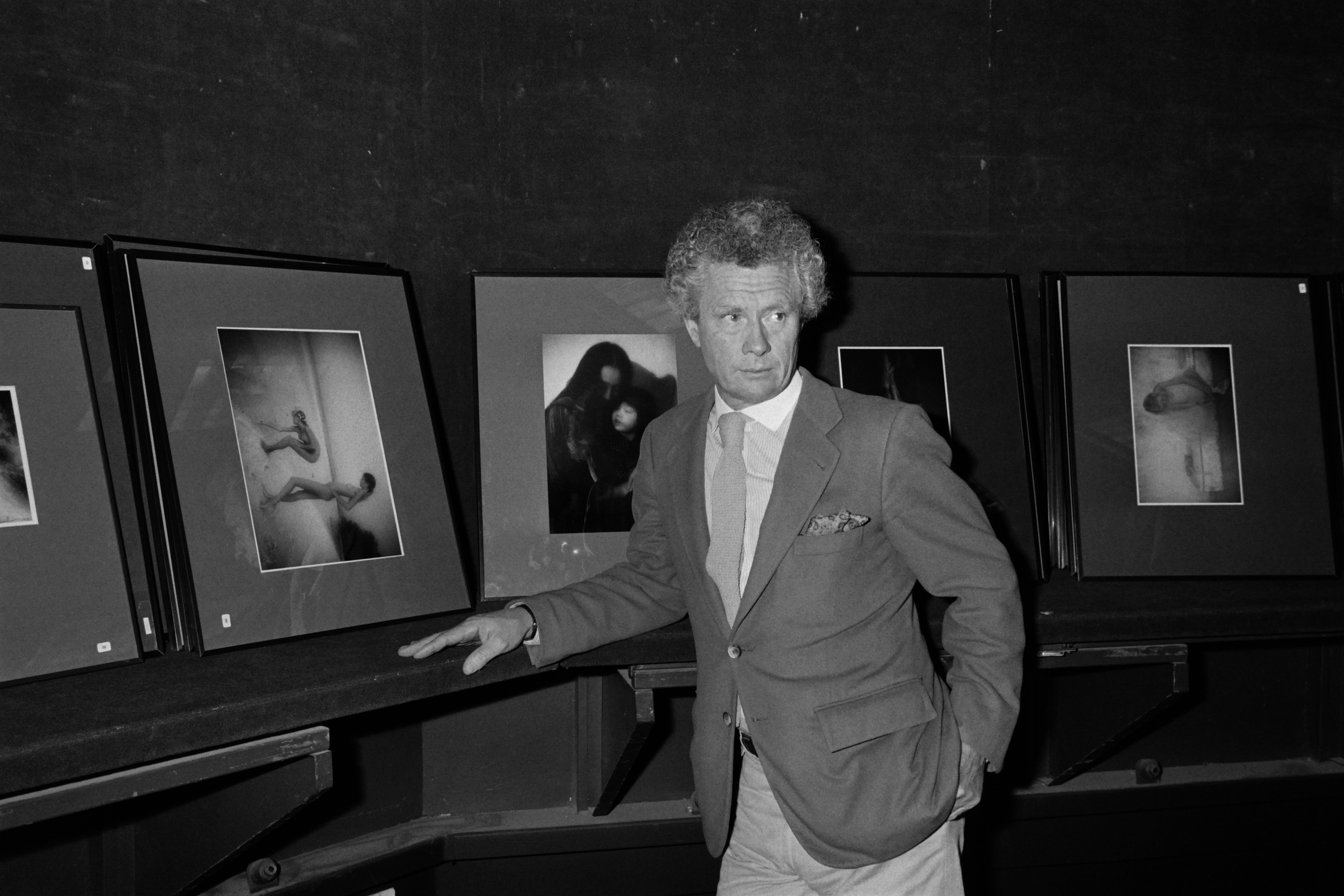 (FILES) This file photo taken on November 19, 1983 shows British photographer and film director David Hamilton posing in front of his work during a sale of his photos at the auction house Drouot in Paris British photographer David Hamilton was found dead at his home in Paris aged 83, on November 25, 2016. / AFP PHOTO / Pierre VERDY