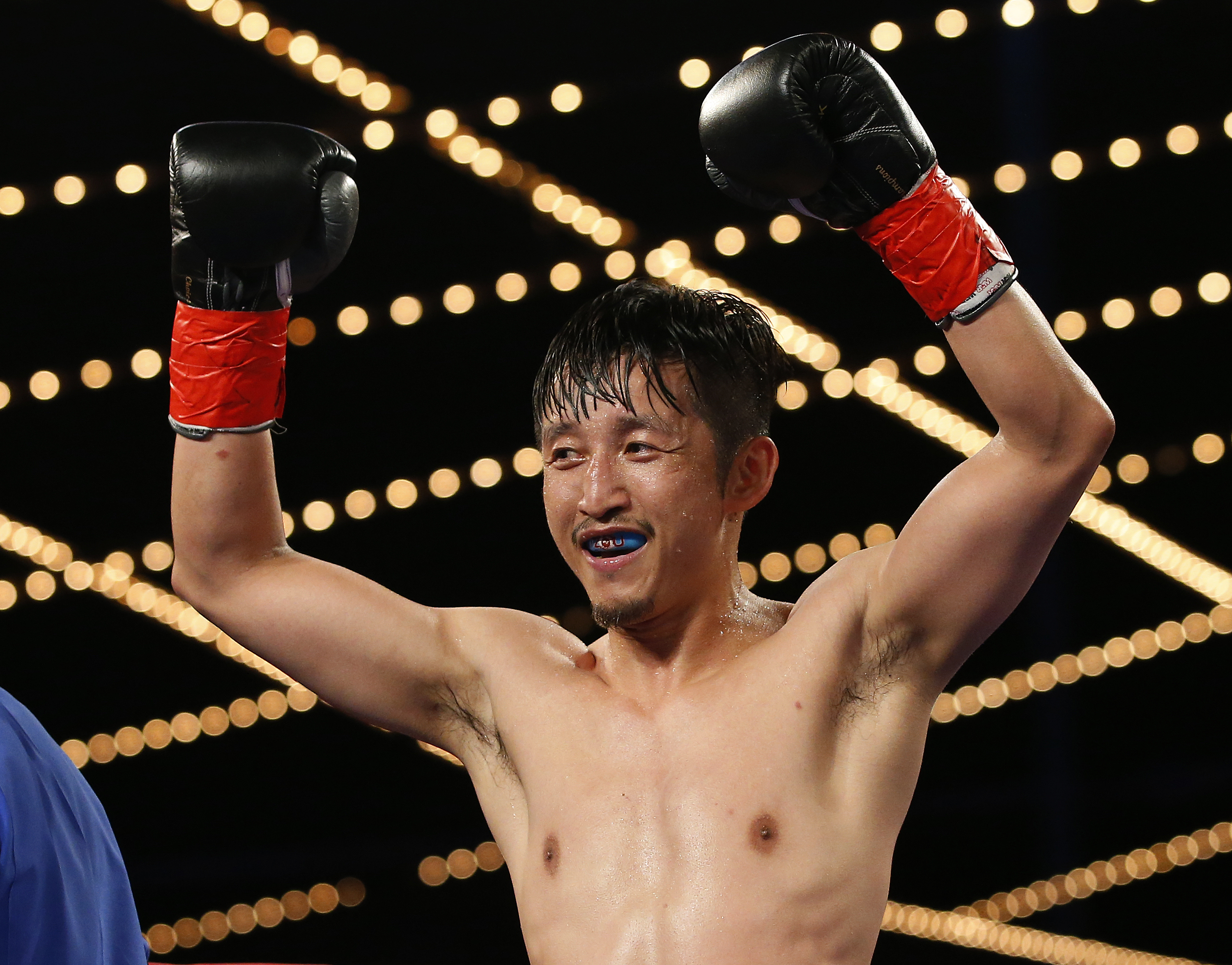 NEW YORK, NY - JUNE 11: Zou Shiming of China celebrates his unanimous decision over Jozsef Ajtai in their Flyweight Championship bout on June 11, 2016 at the Theater at Madison Square Garden in New York City.   Rich Schultz/Getty Images/AFP