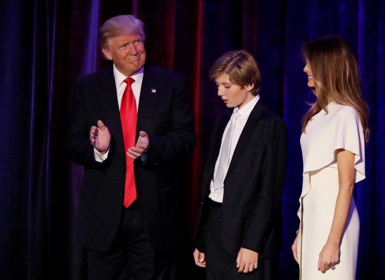 NEW YORK, NY - NOVEMBER 09: Republican president-elect Donald Trump acknowledges the crowd along with his son Barron Trump and his wife Melania Trump during his election night event at the New York Hilton Midtown in the early morning hours of November 9, 2016 in New York City. Donald Trump defeated Democratic presidential nominee Hillary Clinton to become the 45th president of the United States. Joe Raedle/Getty Images/AFP