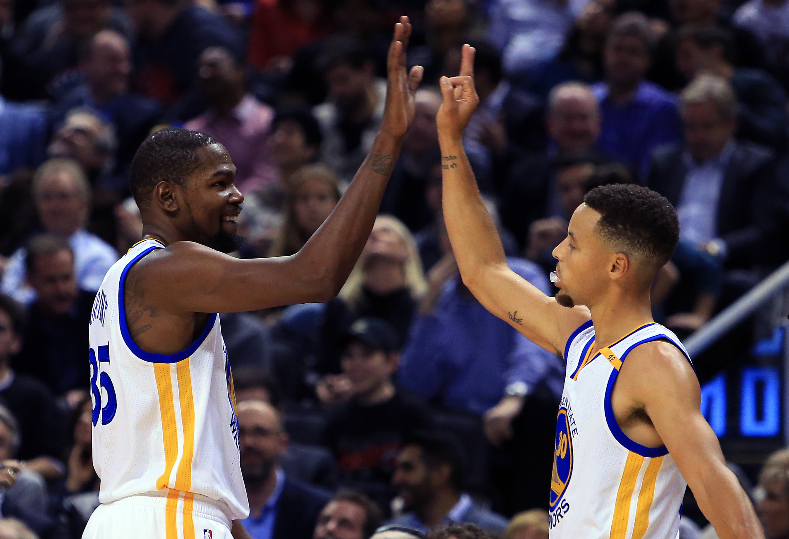 TORONTO, ON - NOVEMBER 16: Kevin Durant #35 and Steph Curry #30 of the Golden State Warriors high five during the first half of an NBA game against the Toronto Raptors at Air Canada Centre on November 16, 2016 in Toronto, Canada. NOTE TO USER: User expressly acknowledges and agrees that, by downloading and or using this photograph, User is consenting to the terms and conditions of the Getty Images License Agreement.   Vaughn Ridley/Getty Images/AFP