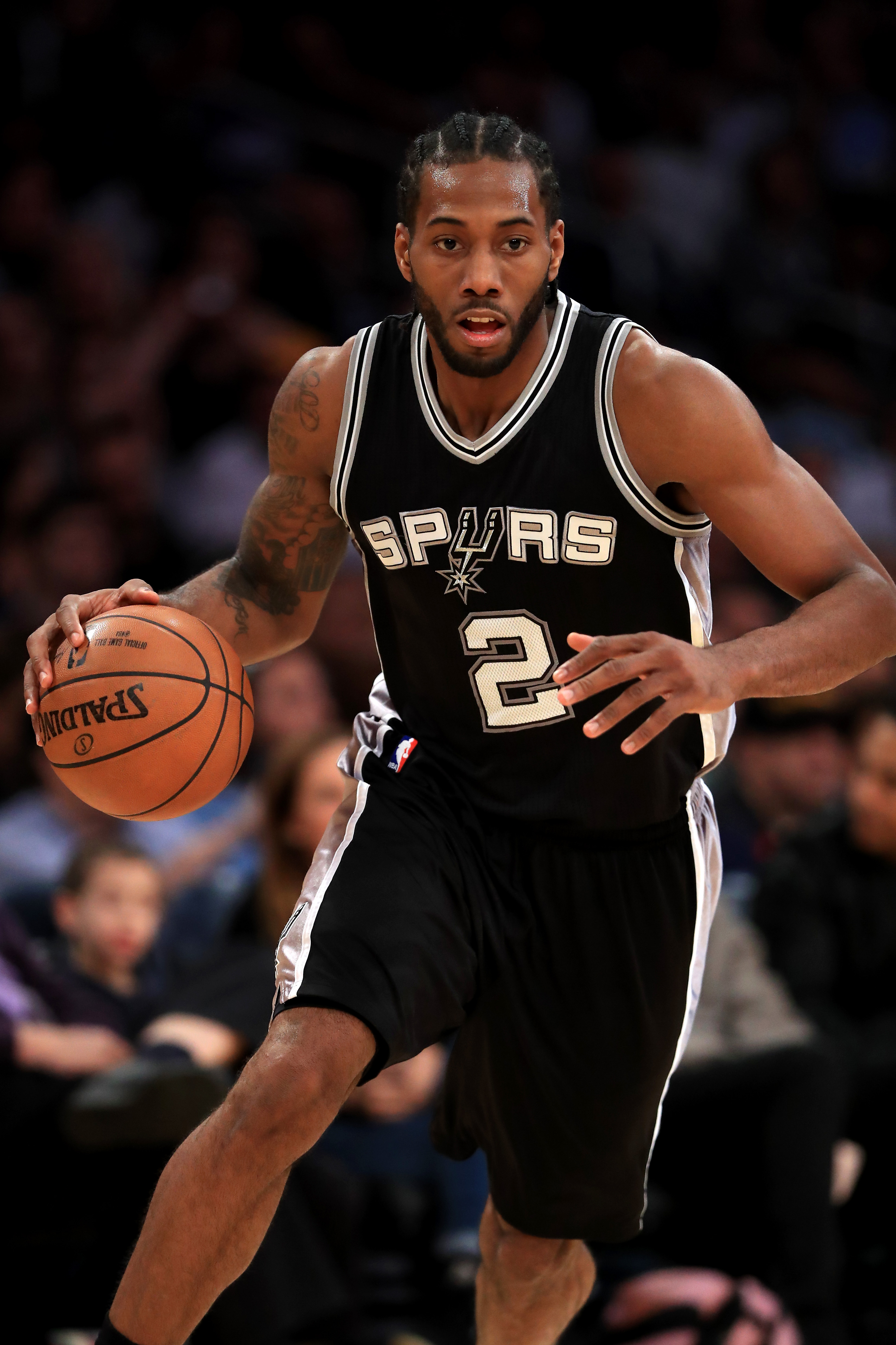 LOS ANGELES, CA - NOVEMBER 18: Kawhi Leonard #2 of the San Antonio Spurs dribbles upcourt during the second half of a game against the Los Angeles Lakers at Staples Center on November 18, 2016 in Los Angeles, California. NOTE TO USER: User expressly acknowledges and agrees that, by downloading and or using this photograph, User is consenting to the terms and conditions of the Getty Images License Agreement Sean M. Haffey/Getty Images/AFP