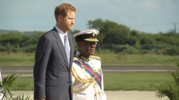 Prince Harry arrives for the first stop on his Caribbean tour in Antigua and Barbuda where he is greeted by a military parade. (Photo grabbed from Reuters video)