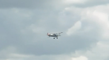 Biplane flying over spectators. (Photo courtesy of Reuters video file)