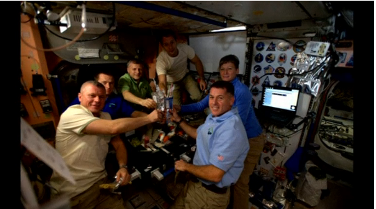 ASTRONAUTS ABOARD THE INTERNATIONAL SPACE STATION ENJOYING THANKSGIVING REHIDRATED MEAL (Photo courtesy of Reuters video file)