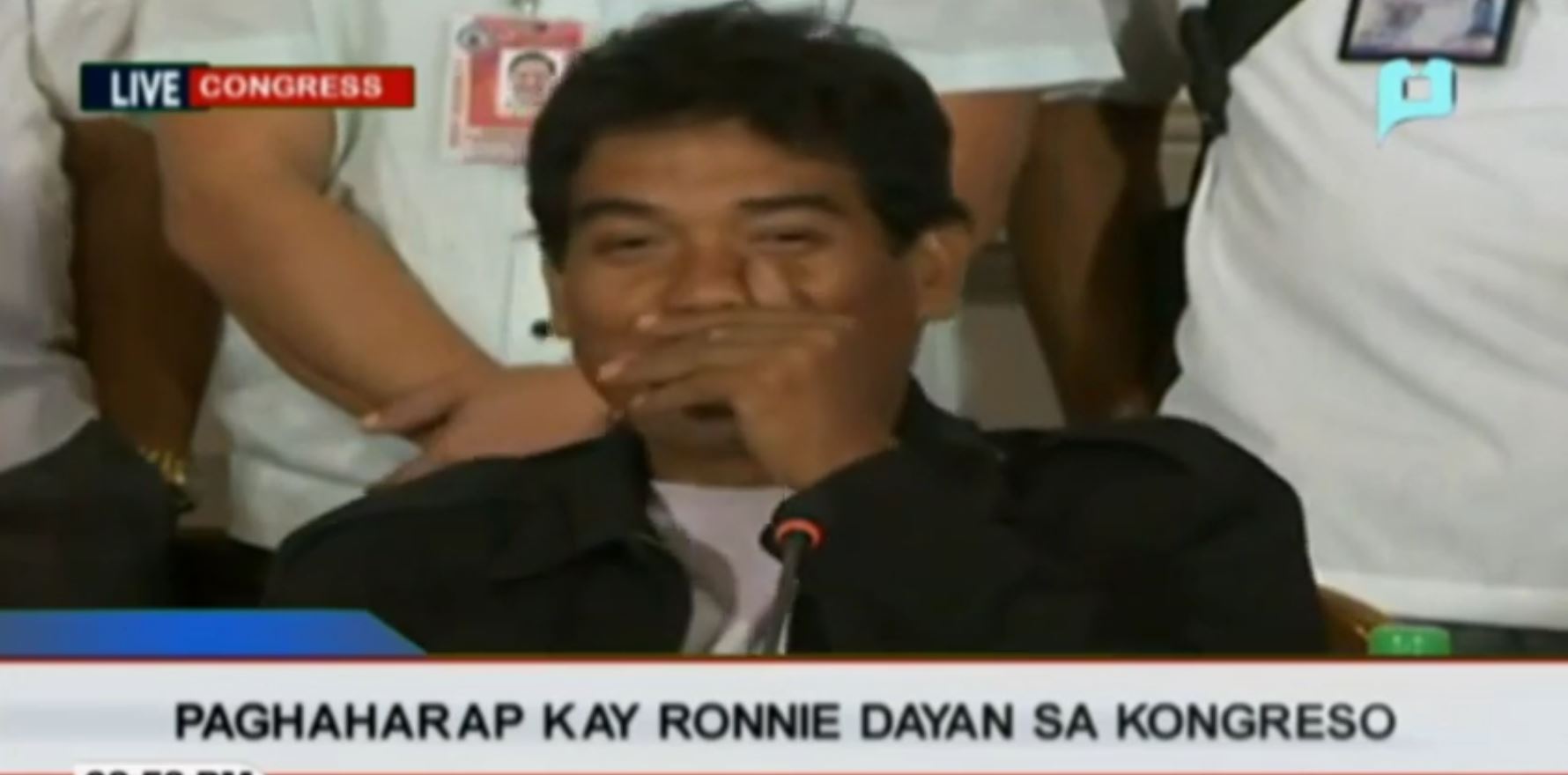 Ronnie Dayan covers his mouth to suppress a smile upon learning of De Lima's meesage of concern for him. (photo grabbed from PTV-4 video)