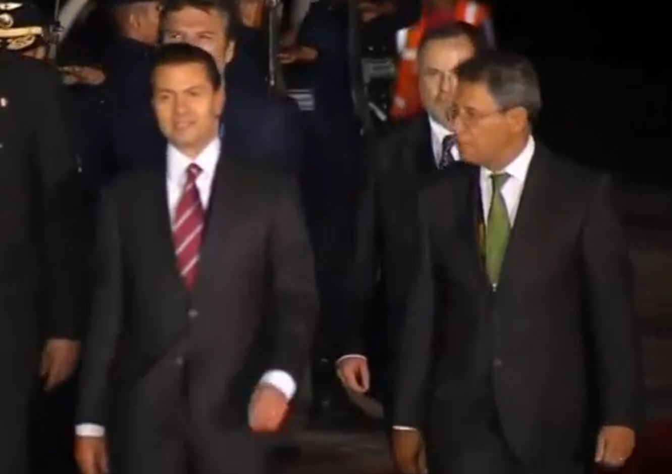 Mexican President Enrique Pena Nieto talks with officials shortly after arriving in Lima, Peru for the APEC Leaders' Summit.  (Photo grabbed from Reuters video)