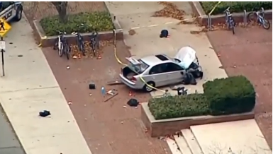 VARIOUS AERIALS OF CAR USED IN ATTACK, DEBRIS AND POLICE TAPE SURROUNDING CAR ON CAMPUS SIDEWALK. (PHOTO COURTESY OF REUTERS VIDEO FILE)