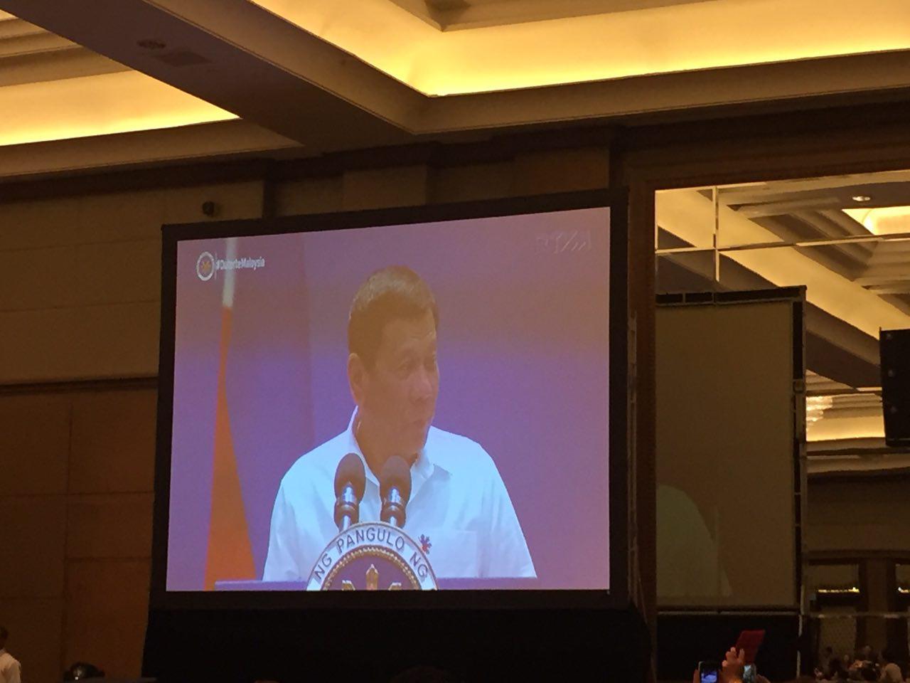President Duterte as seen on a big screen as he is delivering his speech at the Mandarin Hotel in Kuala Lumpur, Malaysia. (Photo from Eagle News Service Malaysia)