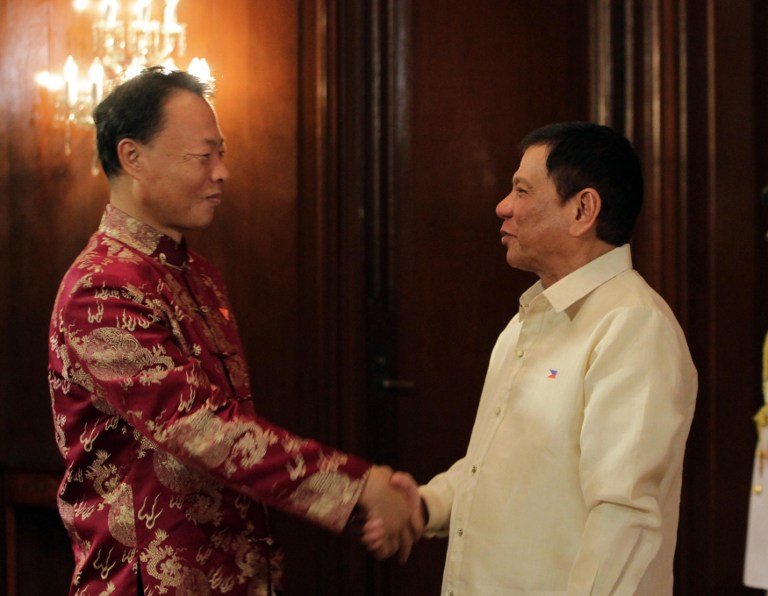 This handout photo taken on June 30, 2016 and released by the Presidential Communication Operations Office (PCOO) shows Philippines President Rodrigo Duterte (R) shakes hands with Chinese Ambassador to the Philippines Zhao Jianhua during the reception after the oath taking ceremony at the Malacanang Palace in Manila. Authoritarian firebrand Rodrigo Duterte was sworn in as the Philippines' president on June 30, after promising a ruthless and deeply controversial war on crime would be the main focus of his six-year term. / AFP PHOTO / PCOO / HO / --- EDITORS NOTE RESTRICTED TO EDITORIAL USE - MANDATORY CREDIT "AFP PHOTO / PRESIDENTIAL COMMUNICATION OPERATIONS OFFICE"- NO MARKETING NO ADVERTISING CAMPAIGNS - DISTRIBUTED AS A SERVICE TO CLIENTS ---