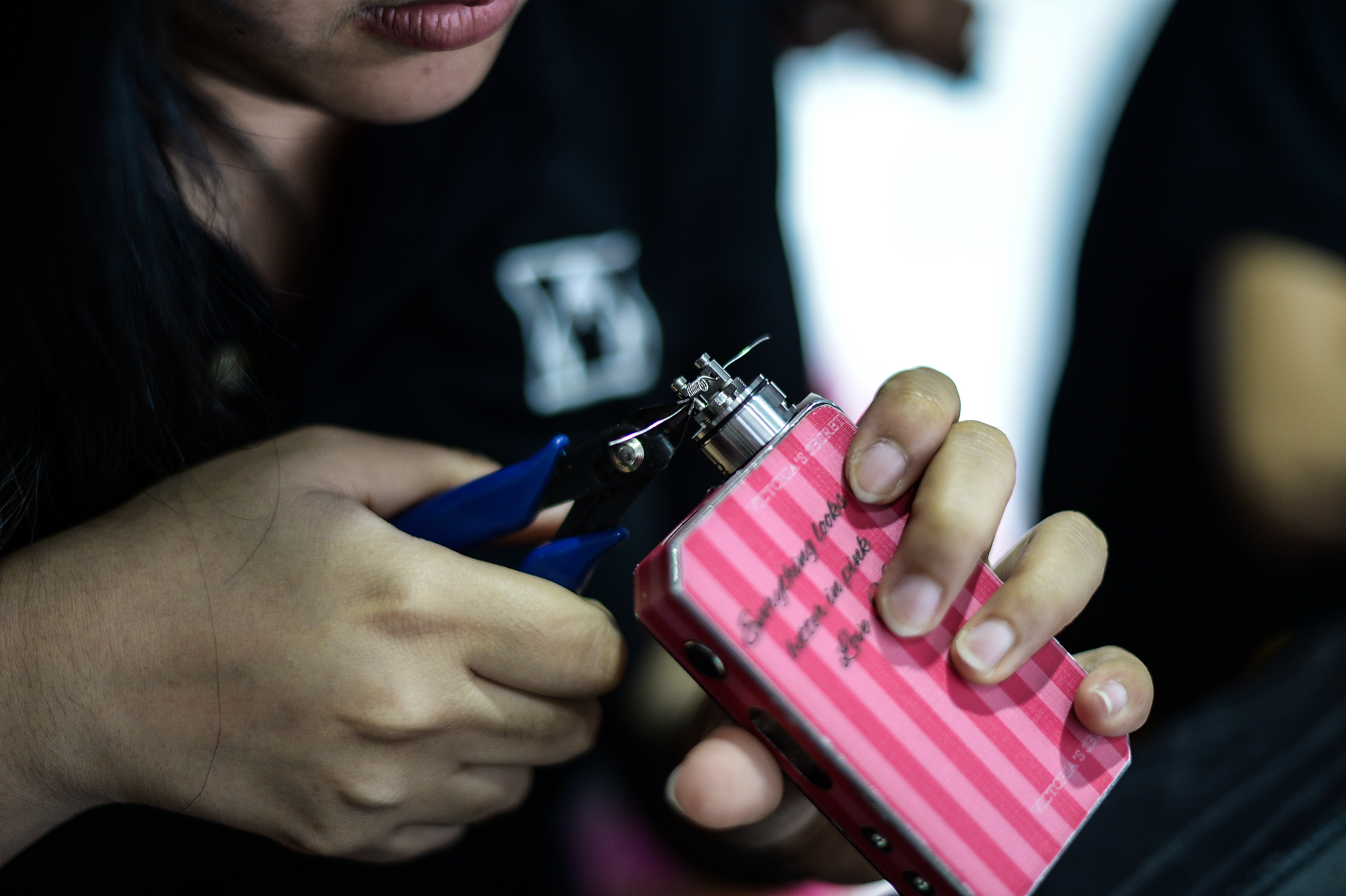TO GO WITH Lifestyle-Malaysia-e-cigarette-tobacco-health,FEATURE by Satish Cheney This picture taken on November 19, 2015 shows a worker inspecting a coil, the metal heating element in an e-cigarette that produces vapour from e-juices, at a vape shop in Kuala Lumpur. Vaping" is soaring in popularity in Malaysia, the largest e-cigarette market in the Asia-Pacific region, but authorities are threatening to ban the habit in for health reasons -- a move that has sparked anger from growing legions of aficionados.     AFP PHOTO / MOHD RASFAN / AFP PHOTO / MOHD RASFAN