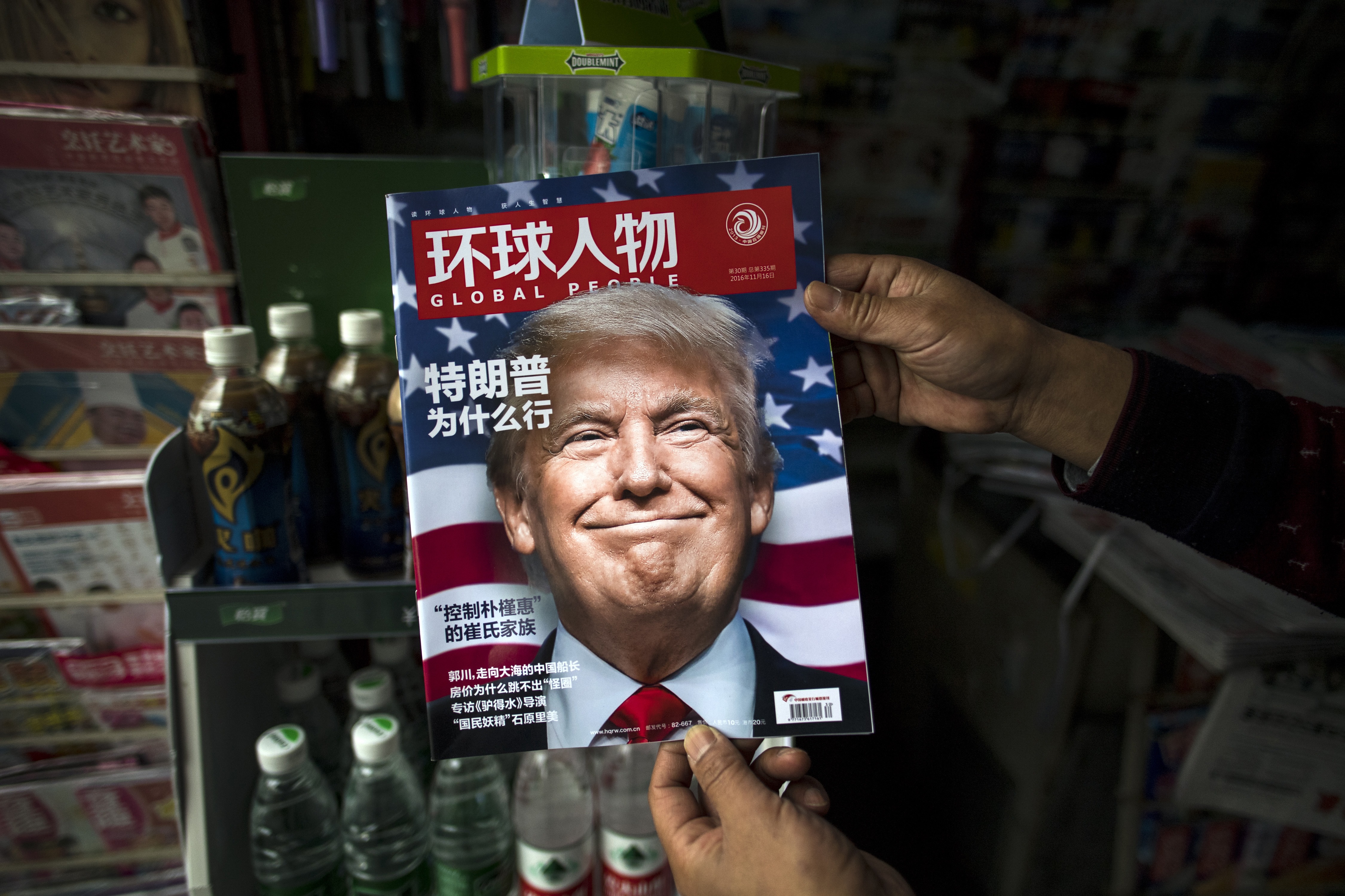 (FILES) This file photo taken on November 14, 2016 shows a copy of the local Chinese magazine Global People with a cover story that translates to "Why did Trump win" at a news stand in Shanghai. US President-elect Donald Trump broke with decades of cautious US diplomacy on December 2 to speak with the president of Taiwan, at the risk of provoking a serious rift with China. / AFP PHOTO / JOHANNES EISELE