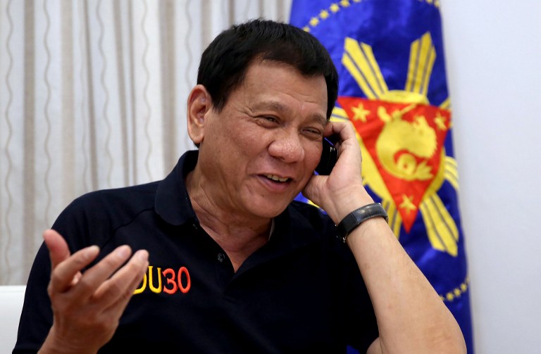 This handout photo taken by the Presidential Photographers' Division on December 2, 2016 and released December 3, 2016 shows Philippines' President Rodrigo Duterte gesturing as he talks to US President-elect Donald Trump on the phone at Legaspi Suites in Davao City. US President-elect Donald Trump told Duterte that Manila was conducting its deadly drug war "the right way", Duterte said on December 3, in stark contrast to the criticism he received from President Barack Obama. / AFP PHOTO / PRESIDENTIAL PHOTOGRAPHERS' DIVISION / Richard Madelo / RESTRICTED TO EDITORIAL USE - MANDATORY CREDIT "AFP PHOTO / PRESIDENTIAL PHOTOGRAPHERS' DIIVISION / RICHARD MADELO " - NO MARKETING - NO ADVERTISING CAMPAIGNS - DISTRIBUTED AS A SERVICE TO CLIENTS