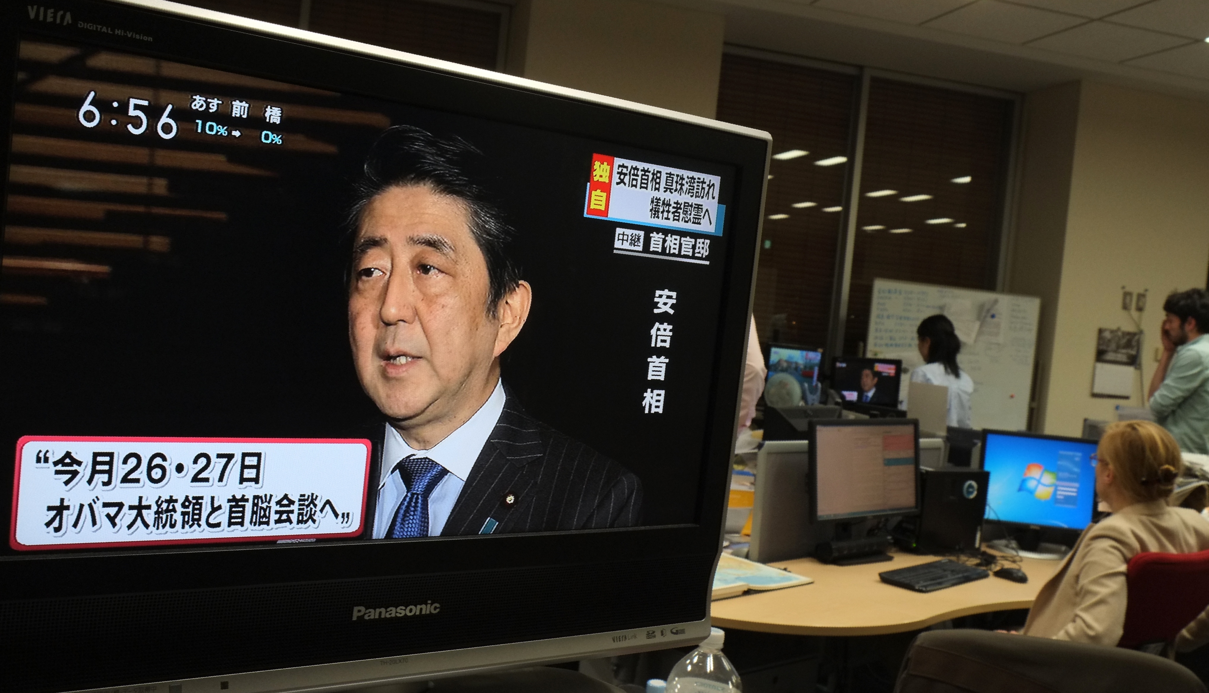 Local television news displays Japan's Prime Minister Shinzo Abe speaking to reporters at his official residence in Tokyo on December 5, 2016.  Abe said on December 5 he will become the first Japanese prime minister to visit Pearl Harbor, announcing a trip to Hawaii later this month for talks with US President Barack Obama. / AFP PHOTO / JIJI PRESS / JIJI PRESS / Japan OUT / The erroneous mention[s] appearing in the metadata of this photo by JIJI PRESS has been modified in AFP systems in the following manner: [Shinzo] instead of [Shizo]. Please immediately remove the erroneous mention[s] from all your online services and delete it (them) from your servers. If you have been authorized by AFP to distribute it (them) to third parties, please ensure that the same actions are carried out by them. Failure to promptly comply with these instructions will entail liability on your part for any continued or post notification usage. Therefore we thank you very much for all your attention and prompt action. We are sorry for the inconvenience this notification may cause and remain at your disposal for any further information you may require.