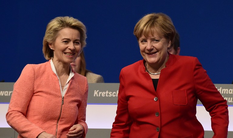 German Defence Minister Ursula von der Leyen (L) and German Chancellor Angela Merkel talk Merkel's re-election as party leader during conservative Christian Democratic Union (CDU) party's congress in Essen, western Germany, on December 6, 2016. / AFP PHOTO / TOBIAS SCHWARZ