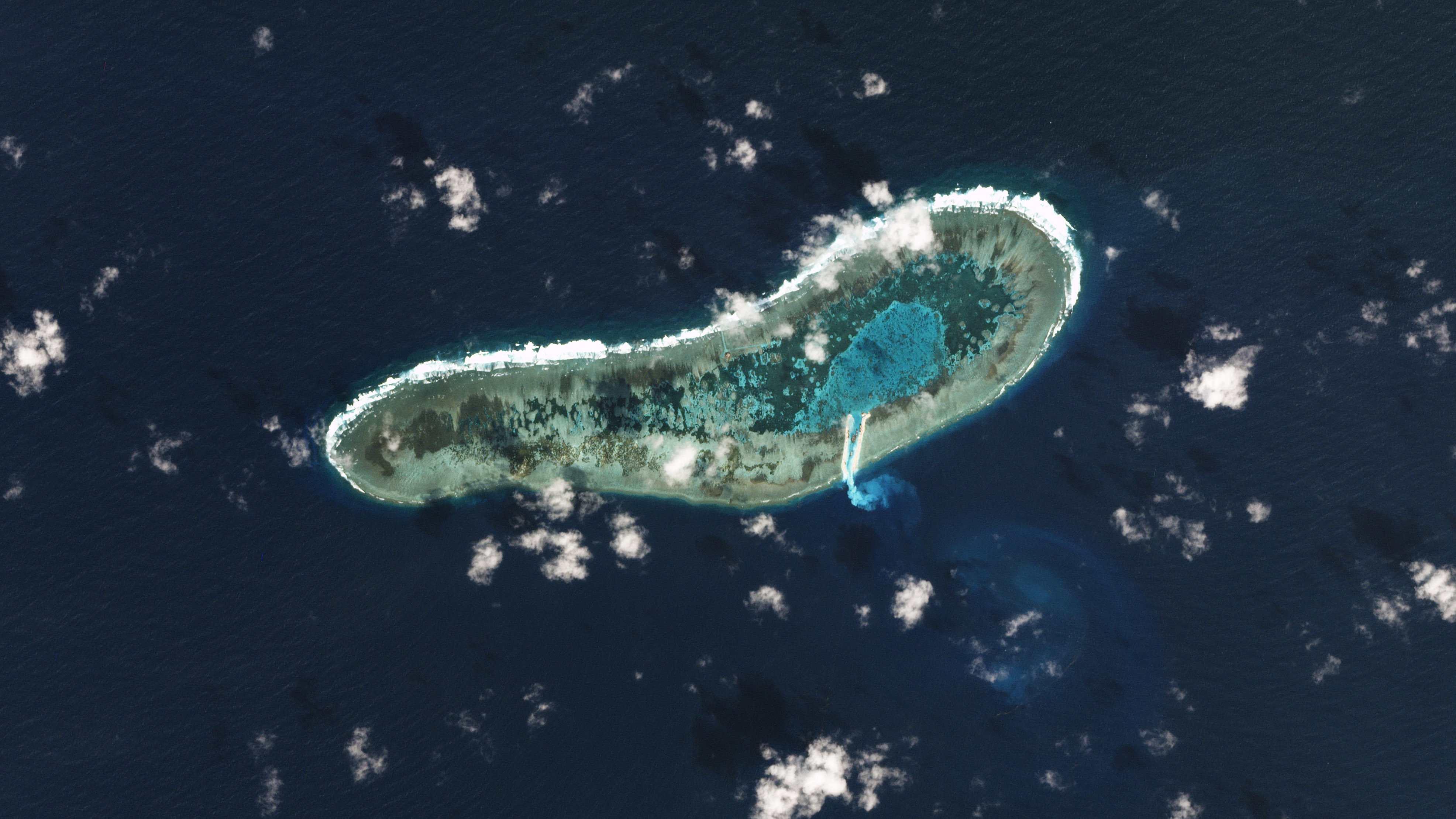 This satellite image taken on November 30, 2016 and released on December 9, 2016 by US-based Planet Labs shows dredging work (C below) on a small reef under Vietnamese control in the South China Sea. Vietnam has started dredging work on reef in the South China Sea, fresh satellite images appear to show, a move that could provoke Beijing which claims most of the disputed waterway. / AFP PHOTO / PLANET LABS / HO / RESTRICTED TO EDITORIAL USE - MANDATORY CREDIT "AFP PHOTO / PLANET LABS" - NO MARKETING NO ADVERTISING CAMPAIGNS - DISTRIBUTED AS A SERVICE TO CLIENTS == NO ARCHIVE