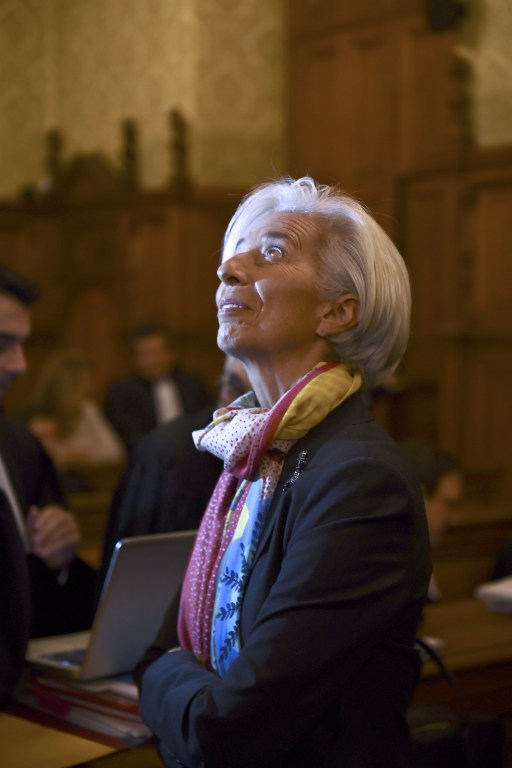 IMF chief Christine Lagarde looks on in a courtroom of the Paris courthouse on December 12, 2016 prior to the start of her trial before the Court of Justice of the Republic, a special tribunal used to try ministers. IMF chief Christine Lagarde goes on trial in France on December 12 over a massive state payout to a flamboyant tycoon when she was finance minister in a case that risks tarnishing her stellar career. / AFP PHOTO / Martin BUREAU