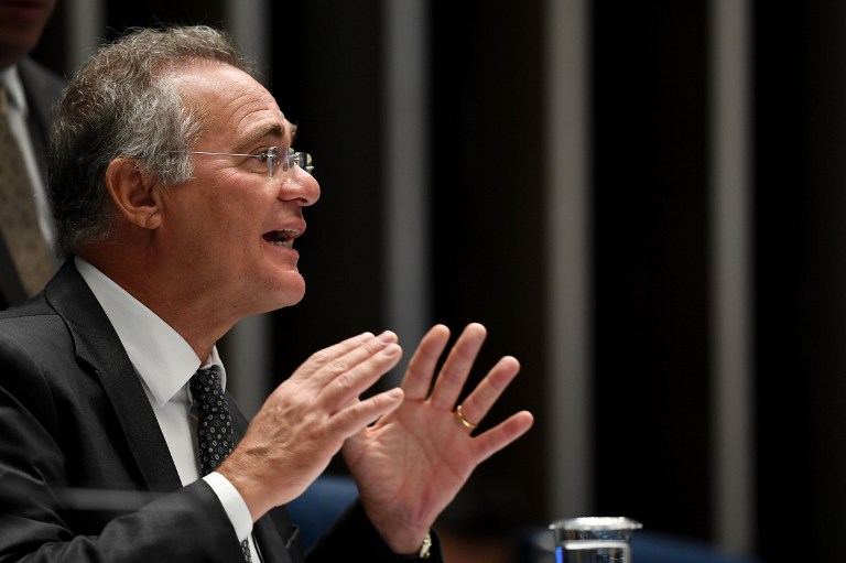 President of the Brazilian Senate Renan Calheiros gestures during a Senate plenary to vote on the constitutional amendment that establishes the limit of expenses for the government in the annual budget, as the centrepiece of austerity reforms that have provoked violent protests, in Brasilia on December 13, 2016. Police were out in force in the capital Brasilia to protect government buildings from demonstrators during the upper house vote. The spending cap would be locked into the constitution and is the central plank in proposals by center-right President Michel Temer to get Brazil's finances back under control and attract investors who fled because of Brazil's ongoing recession  / AFP PHOTO / EVARISTO SA