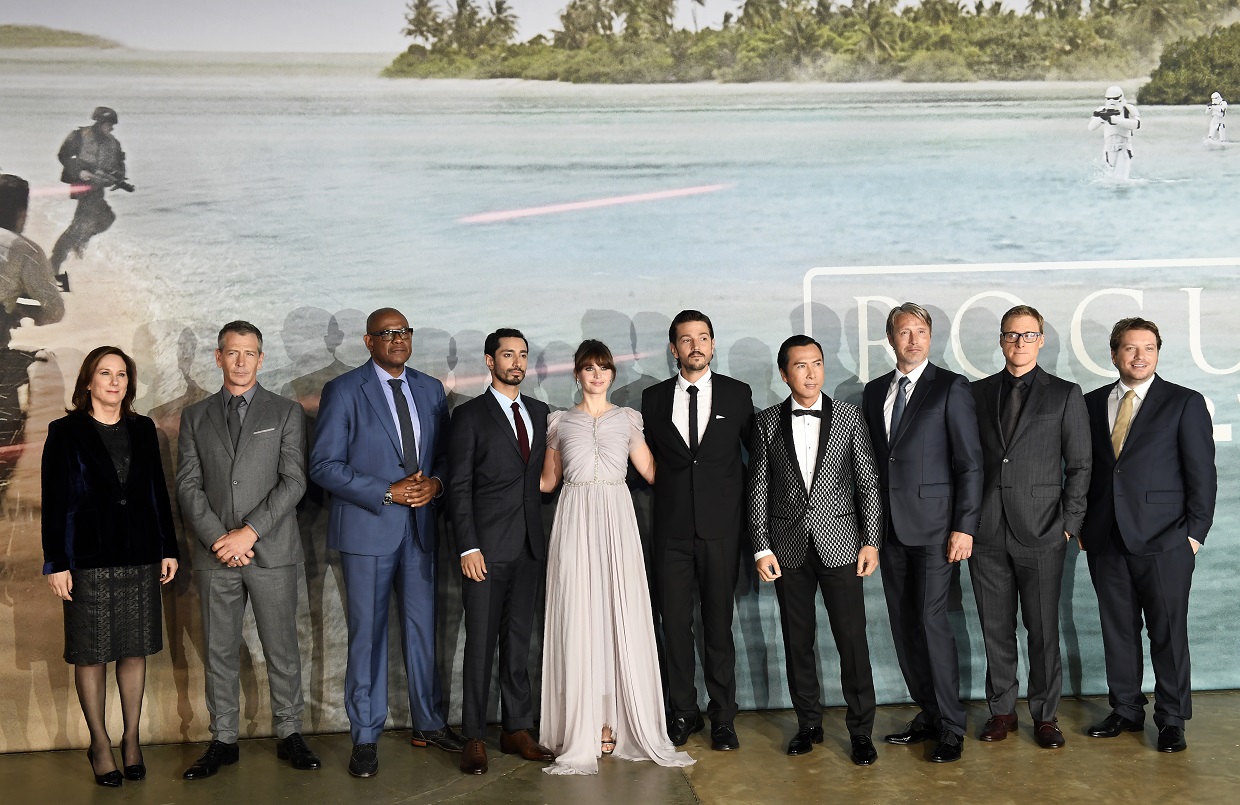 (FILES) This file photo taken on December 13, 2016 shows British actress Felicity Jones (C)as she poses with cast members upon arrival at the UK launch event of Lucasfilm's "Rogue One: A Star Wars Story", at the Tate Modern in central London. The latest blockbuster episode in the "Star Wars" anthology dominated weekend box offices in North America, humbling another popular Disney film, "Moana," according to industry estimates reported December 18, 2016. "Rogue One: A Star Wars Story" raked in $155 million for the three-day weekend, Exhibitor Relations said. It has brought in $290 million globally, and has yet to open in the vast Chinese market. / AFP PHOTO / Justin TALLIS