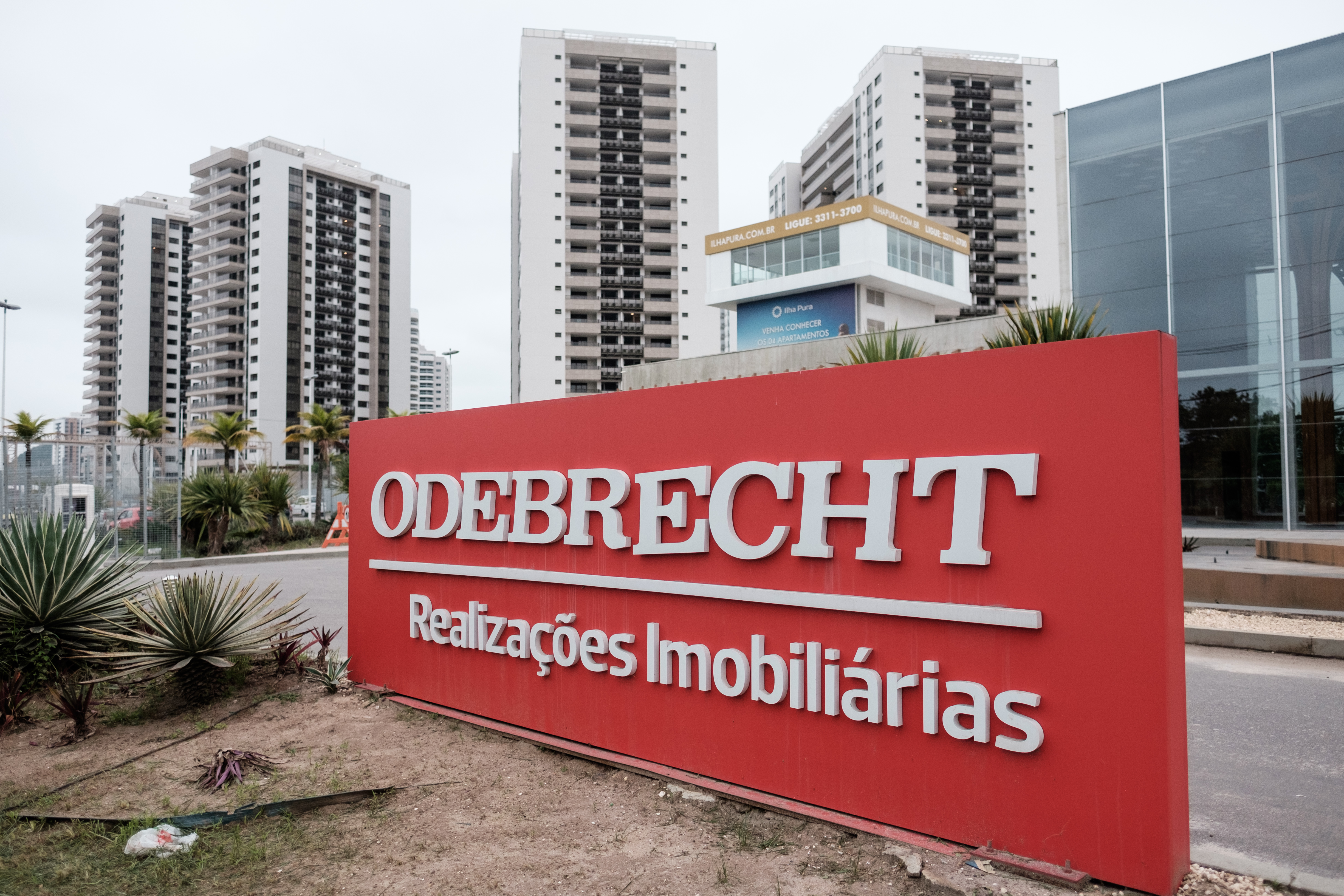(FILES) This file photo taken on June 23, 2016 shows a logo of Brazilian construction company Odebrecht at the Olympic and Paralympic Village in Rio de Janeiro, Brazil. Brazil-based construction giant Odebrecht on December 21, 2016 agreed to pay fines of at least $2.6 billion to US, Brazilian and Swiss authorities, in what the US is calling the largest foreign bribery case in history. The US Justice Department said the conglomerate pled guilty to paying hundreds of millions to bribe government officials in countries on three continents.  / AFP PHOTO / YASUYOSHI CHIBA