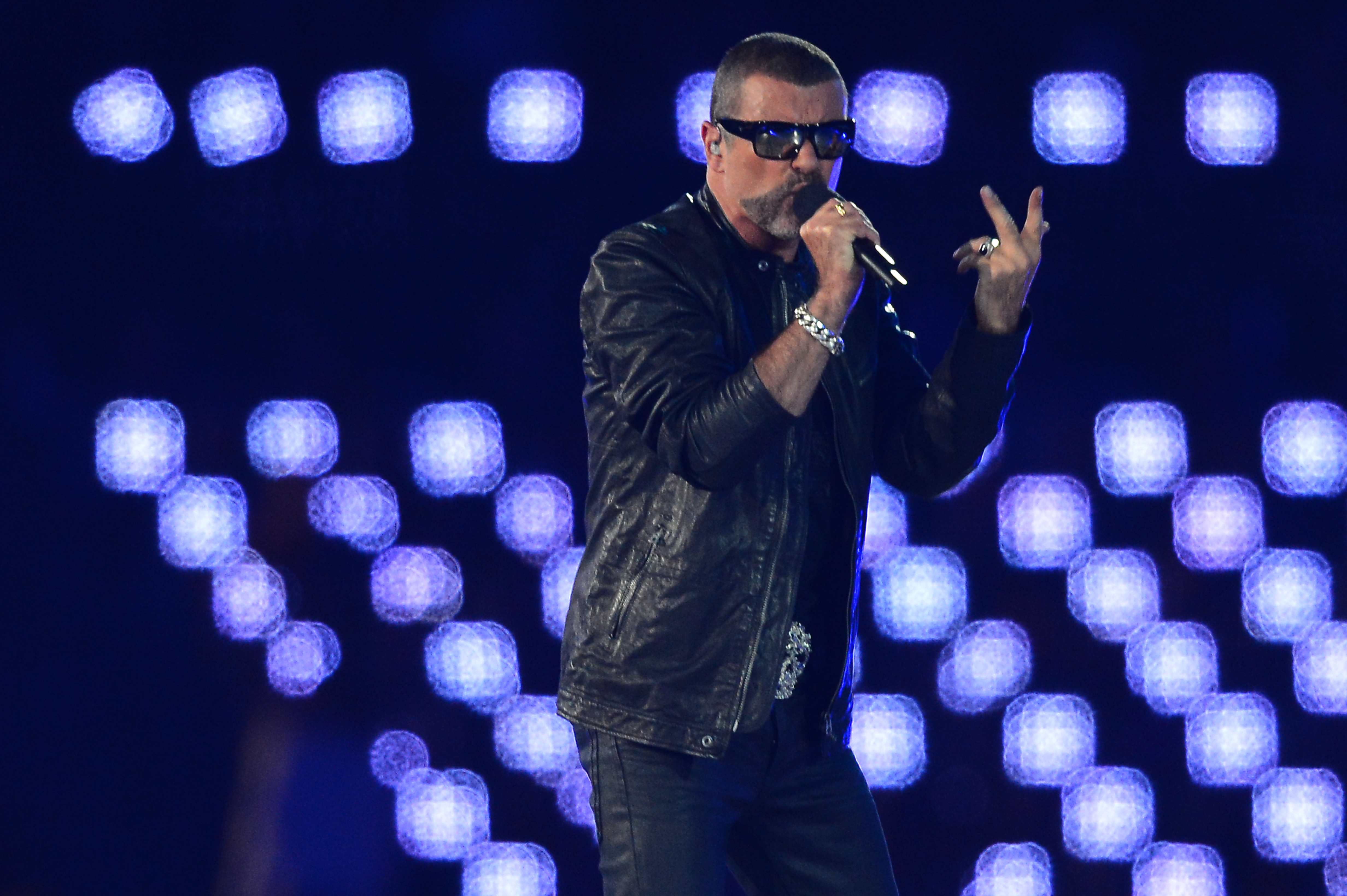 (FILES) This file photo taken on August 12, 2012 shows British singer George Michael performing at the Olympic stadium during the closing ceremony of the 2012 London Olympic Games in London. British pop singer George Michael, who rose to fame with the band Wham! and sold more than 100 million albums in his career, has died aged 53, his publicist said on December 25, 2016. / AFP PHOTO / JEWEL SAMAD