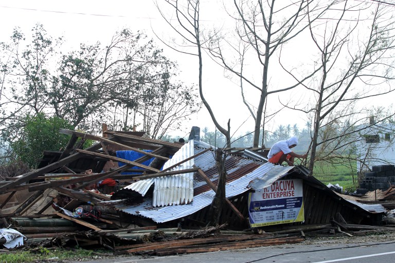 A resident inspects his house which was damaged by Typhoon Nock-Ten in Tabaco, Albay province in December 27, 2016. At least six people are dead and 18 others missing after Typhoon Nock-Ten lashed the Philippines over the  holidays, the government said on December 27 as it tried to assess the damage. / AFP PHOTO / Charism SAYAT
