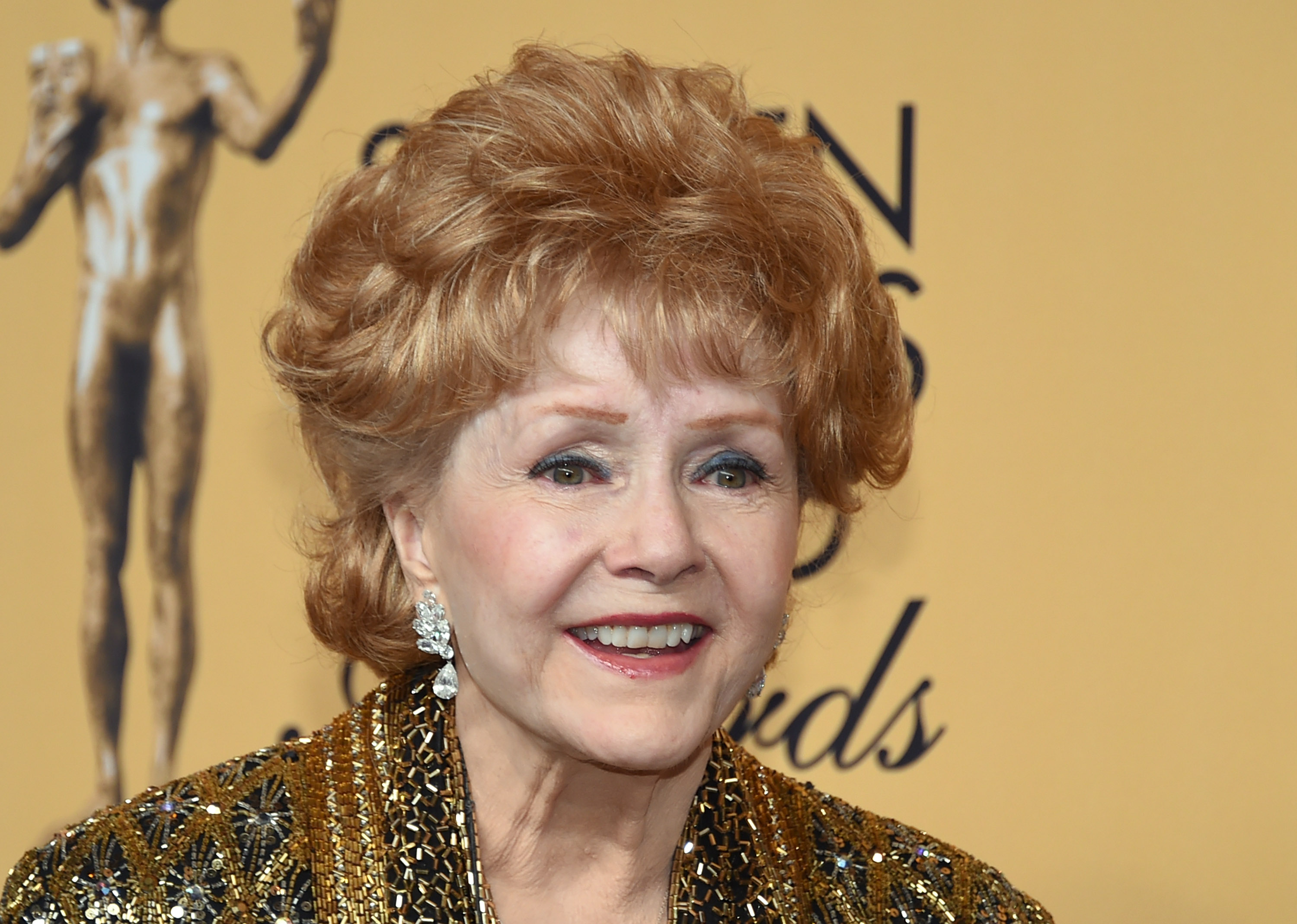 (FILES) This file photo taken on January 24, 2015 shows actress Debbie Reynolds, recipient of the Screen Actors Guild Life Achievement Award, posing in the press room during the 21st Annual Screen Actors Guild Awards at The Shrine Auditorium in Los Angeles, California. Film legend Debbie Reynolds was rushed to hospital on December 28, 2016 after suffering a possible stroke, a day after the death of her movie star daughter Carrie Fisher, emergency services and US media said. / AFP PHOTO / GETTY IMAGES NORTH AMERICA / Ethan Miller