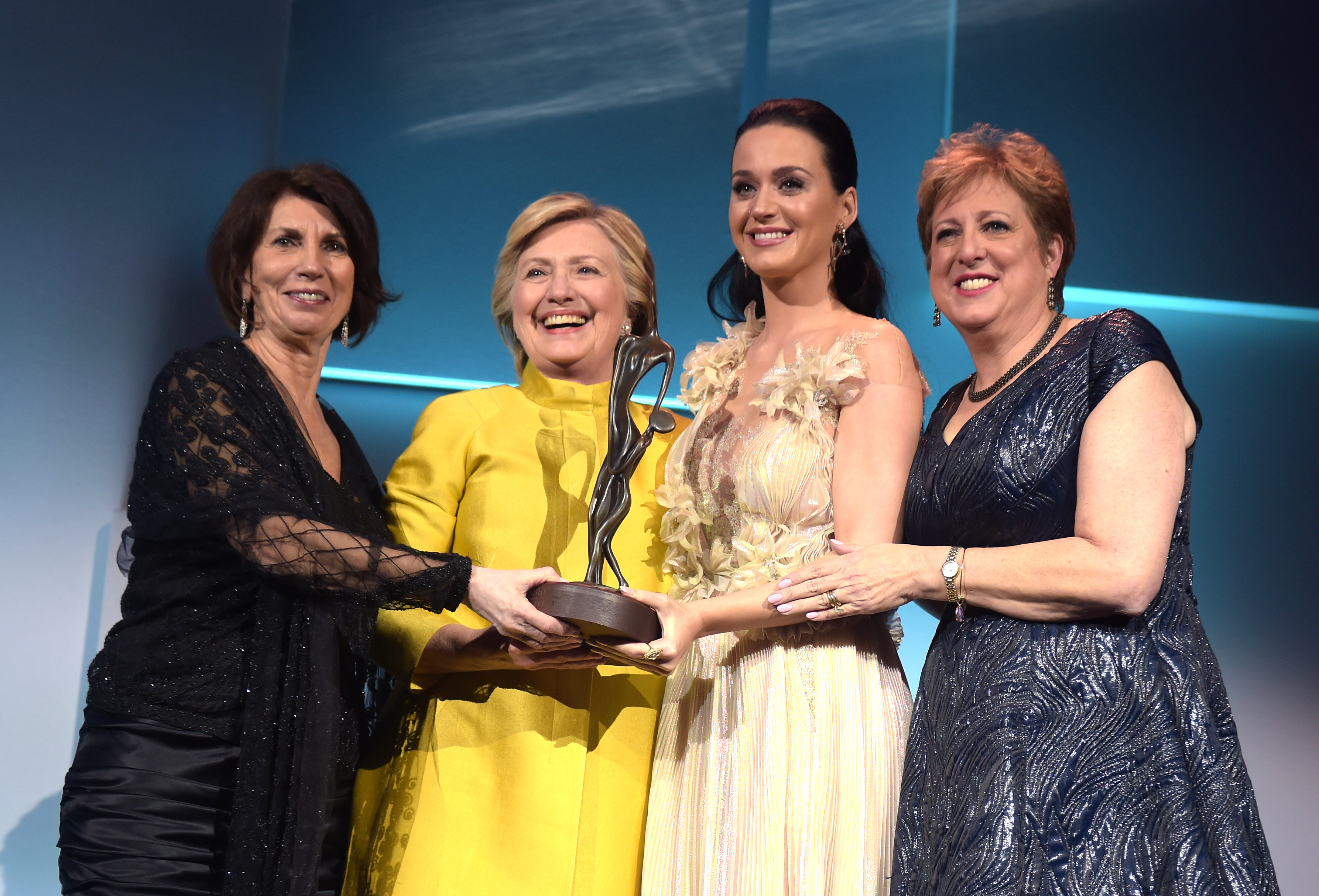 NEW YORK, NY - NOVEMBER 29: (L-R) Pamela Fiori, Hillary Clinton, Katy Perry, and Caryl Stern speak on stage during the 12th annual UNICEF Snowflake Ball at Cipriani Wall Street on November 29, 2016 in New York City.   Jason Kempin/Getty Images for UNICEF/AFP