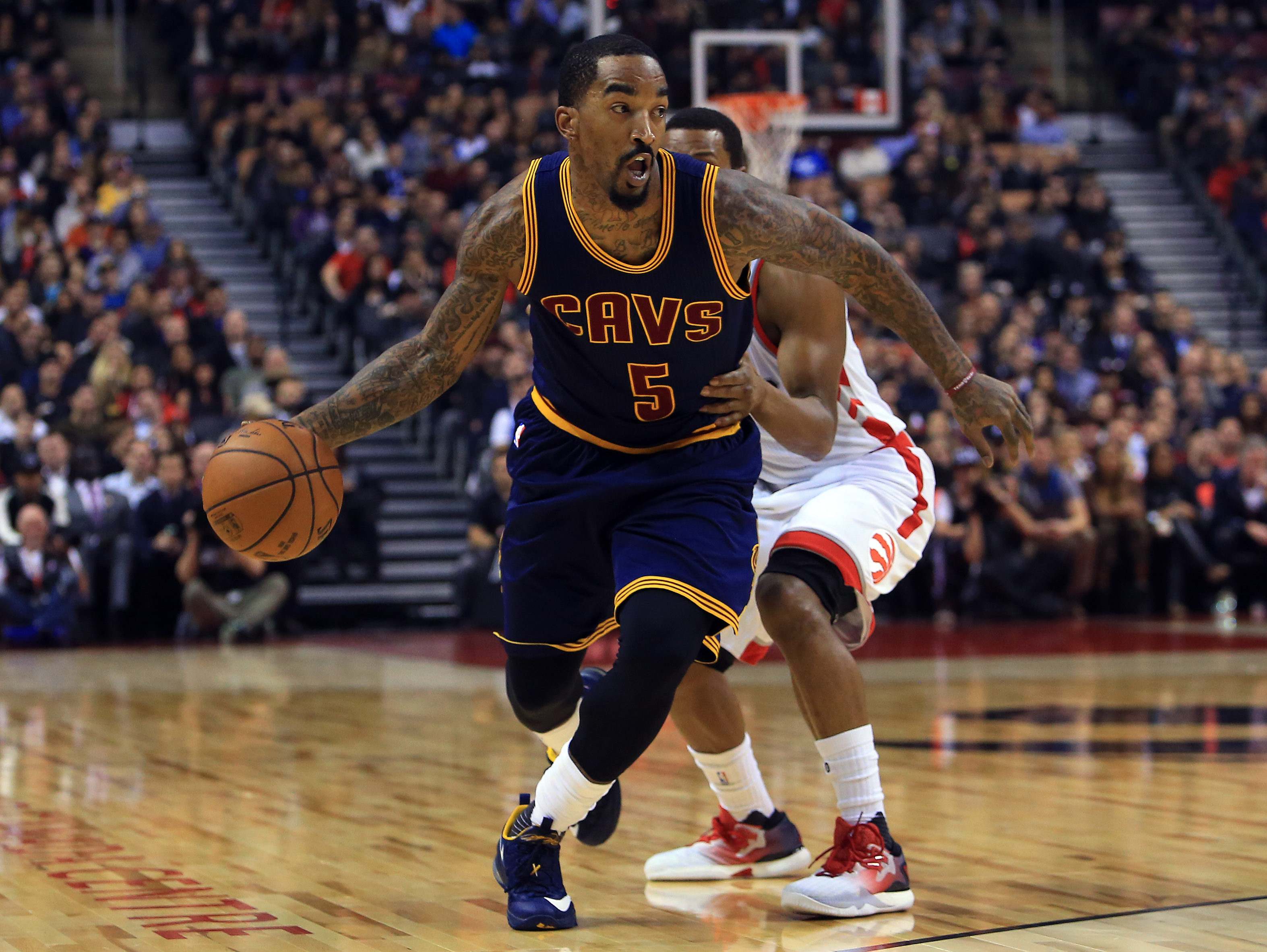 TORONTO, ON - DECEMBER 05: J.R.Smith #5 of the Cleveland Cavaliers dribbles the ball as Kyle Lowry #7 of the Toronto Raptors defends during the first half of an NBA game at Air Canada Centre on December 5, 2016 in Toronto, Canada. NOTE TO USER: User expressly acknowledges and agrees that, by downloading and or using this photograph, User is consenting to the terms and conditions of the Getty Images License Agreement.   Vaughn Ridley/Getty Images/AFP
