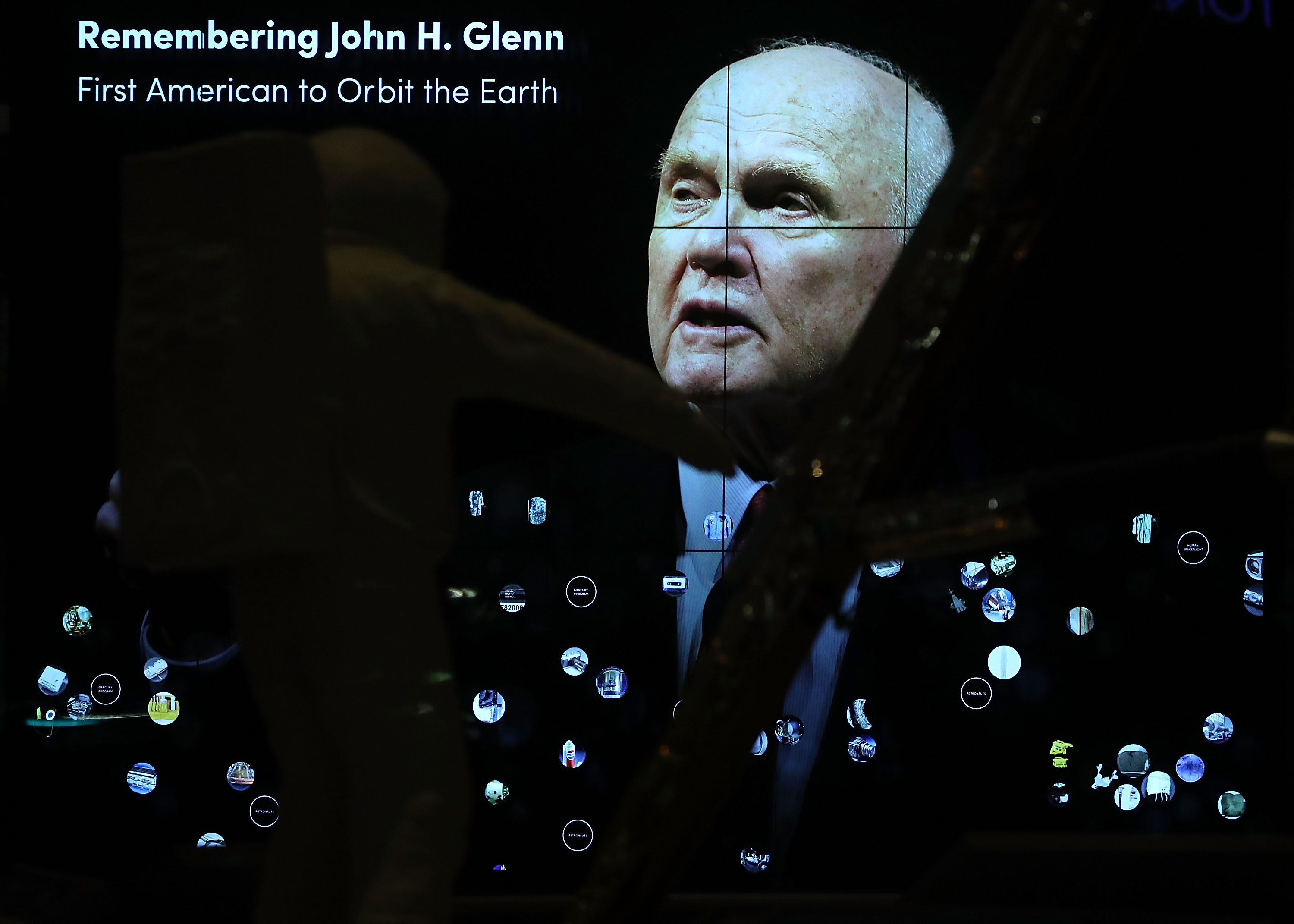 WASHINGTON, DC - DECEMBER 08: A tribute can be seen through the window of the closed National Air and Space Museum to honor the former Astronaut, and US Senator John Glenn, who passed away today at the age of 95, December 8, 2016 in Washington, DC. Glenn was the first man to orbit the earth, and later served 24 years as a US Senator for the state of Ohio. Mark Wilson/Getty Images/AFP