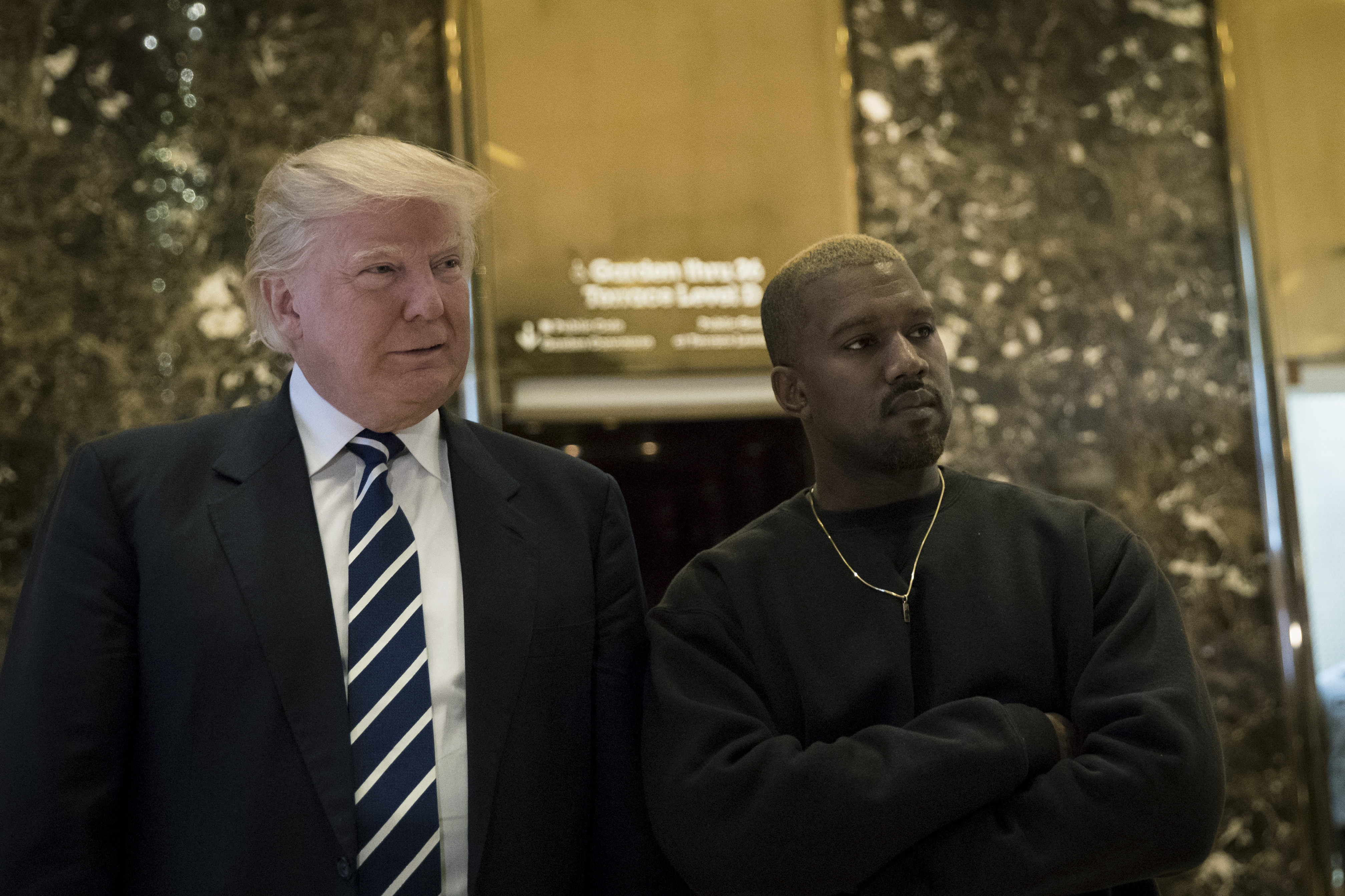 NEW YORK, NY - DECEMBER 13: (L to R) President-elect Donald Trump and Kanye West stand together in the lobby at Trump Tower, December 13, 2016 in New York City. President-elect Donald Trump and his transition team are in the process of filling cabinet and other high level positions for the new administration.   Drew Angerer/Getty Images/AFP