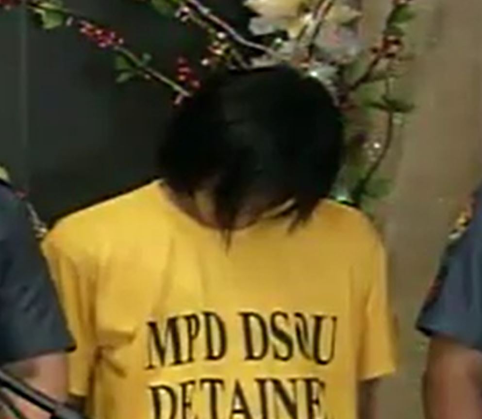 The third suspect, Muhammad Jumao-as, presented by the police to the media in Camp Crame, Quezon City, kept his head down, trying to hide his face during the press briefing held in Camp Crame. 
