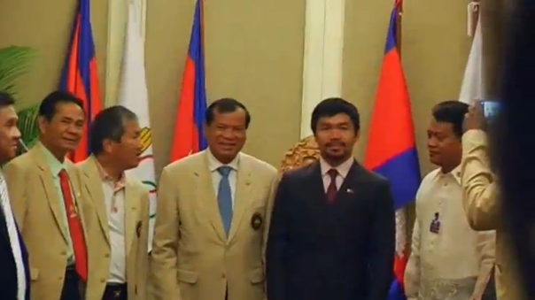 Filipino boxer Manny Pacquiao meets with Cambodian Tourism Minister Thoang Khon and local boxers in Phnom Penh. (Photo grabbed from Reuters video)