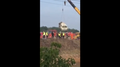 Crane lifting damaged bus out of water. (Photo courtesy of Reuters video file)