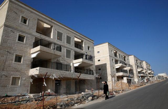 An ultra-Orthodox Jewish man walks past buildings under construction in the Israeli settlement of Beitar Ilit, in the occupied West Bank December 22, 2016. REUTERS/Baz Ratner
