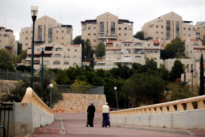A couple walk in the Israeli settlement of Maale Edumim, in the occupied West Bank December 24, 2016. REUTERS/Amir Cohen